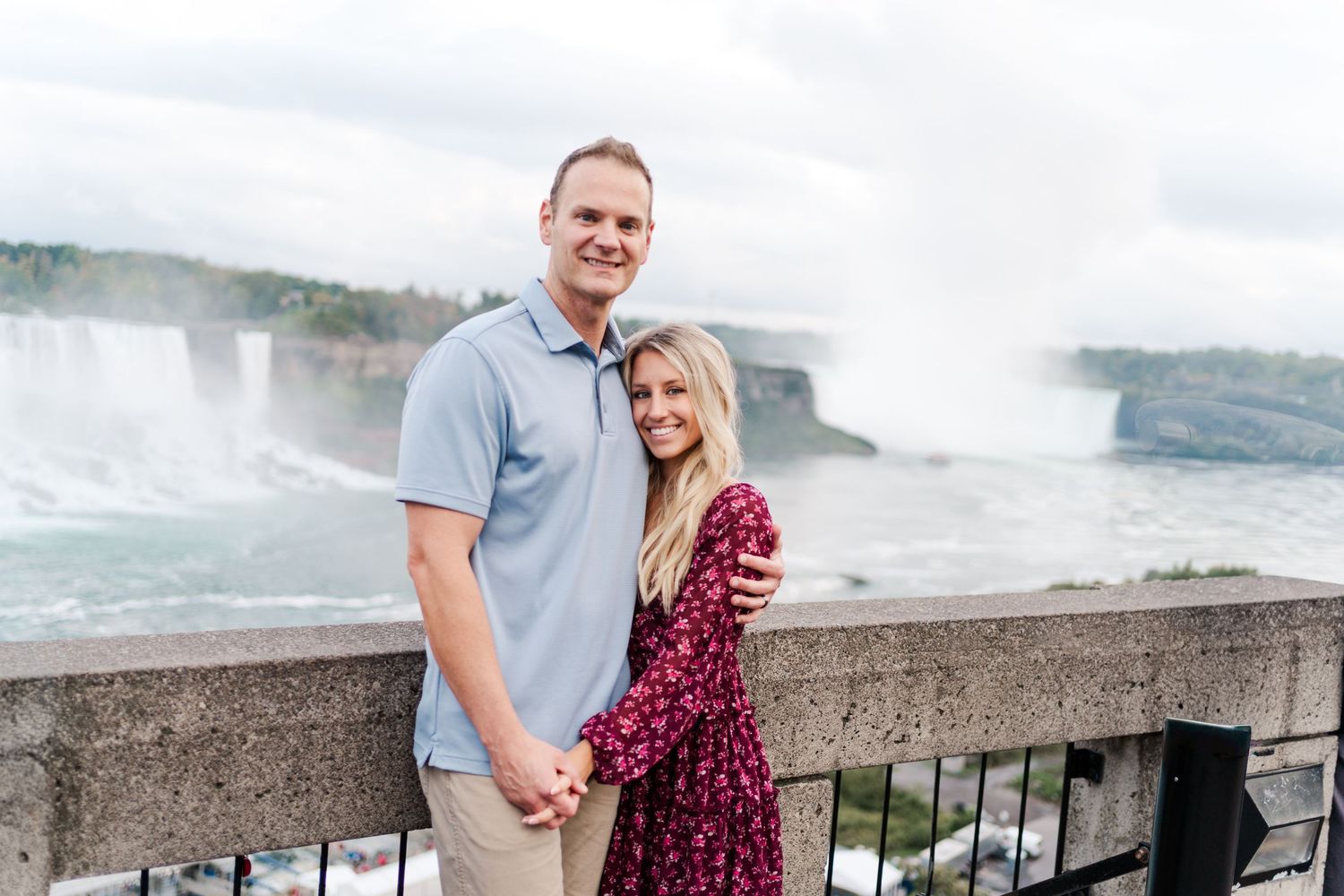 Couple posing for engagement photos with the majestic Niagara Falls in the background.
Niagara engagement photos.