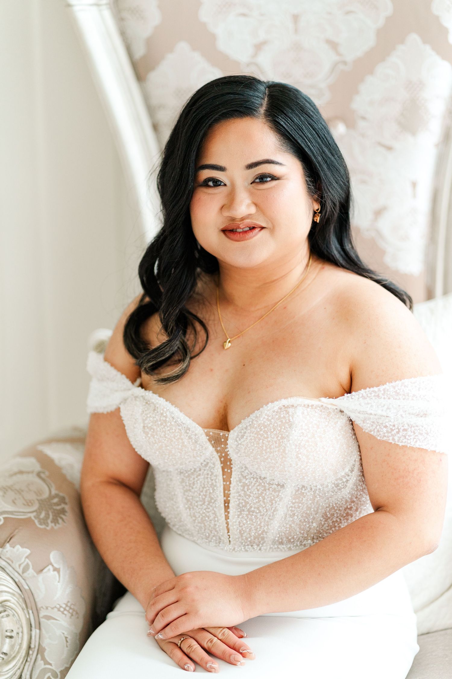 Elegant bridal portrait in white lace dress against light background.
Niagara Wedding photography.