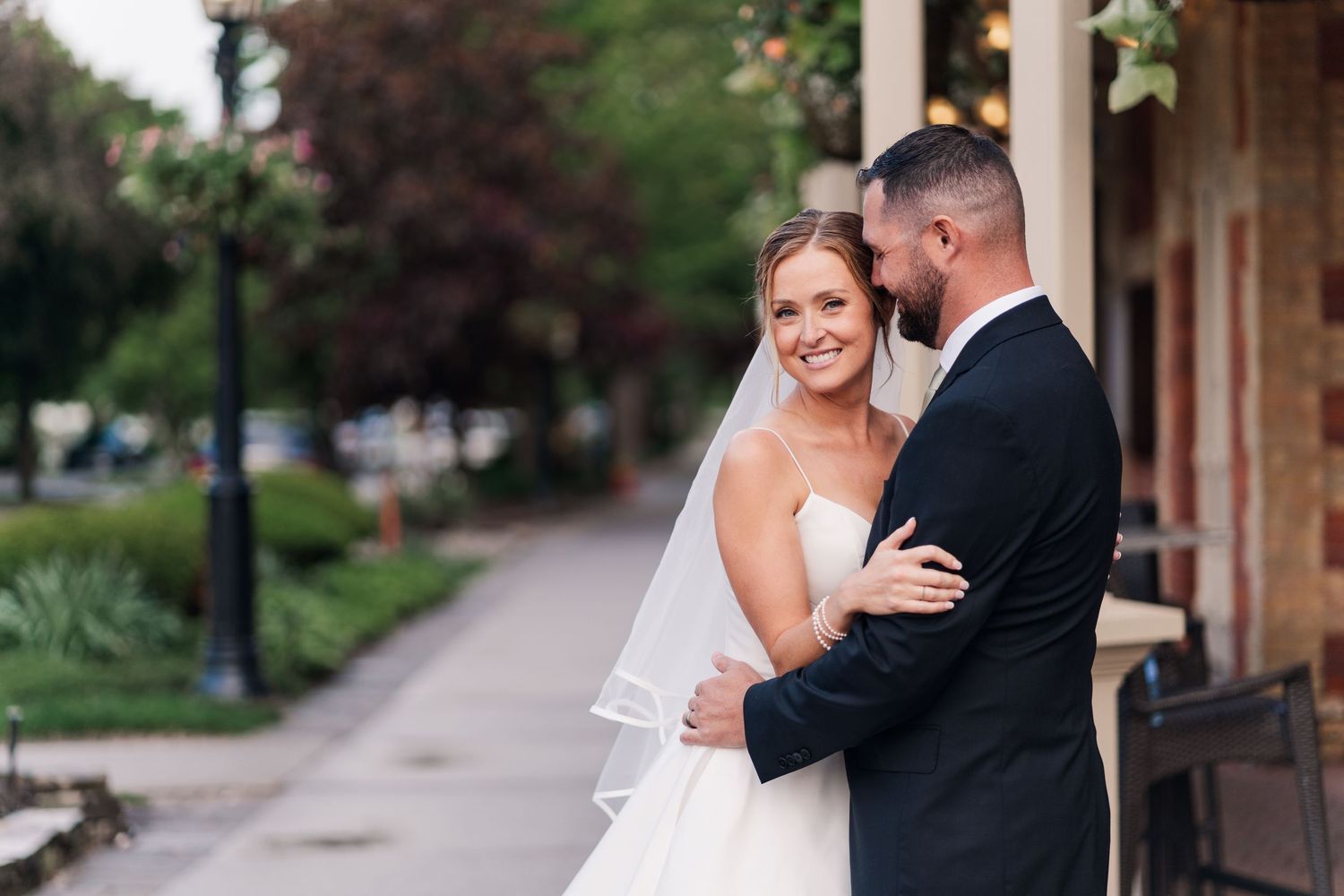 A romantic wedding couple embraces on the steps of a stone building in an elegant outdoor setting.
Wedding in Niagara.