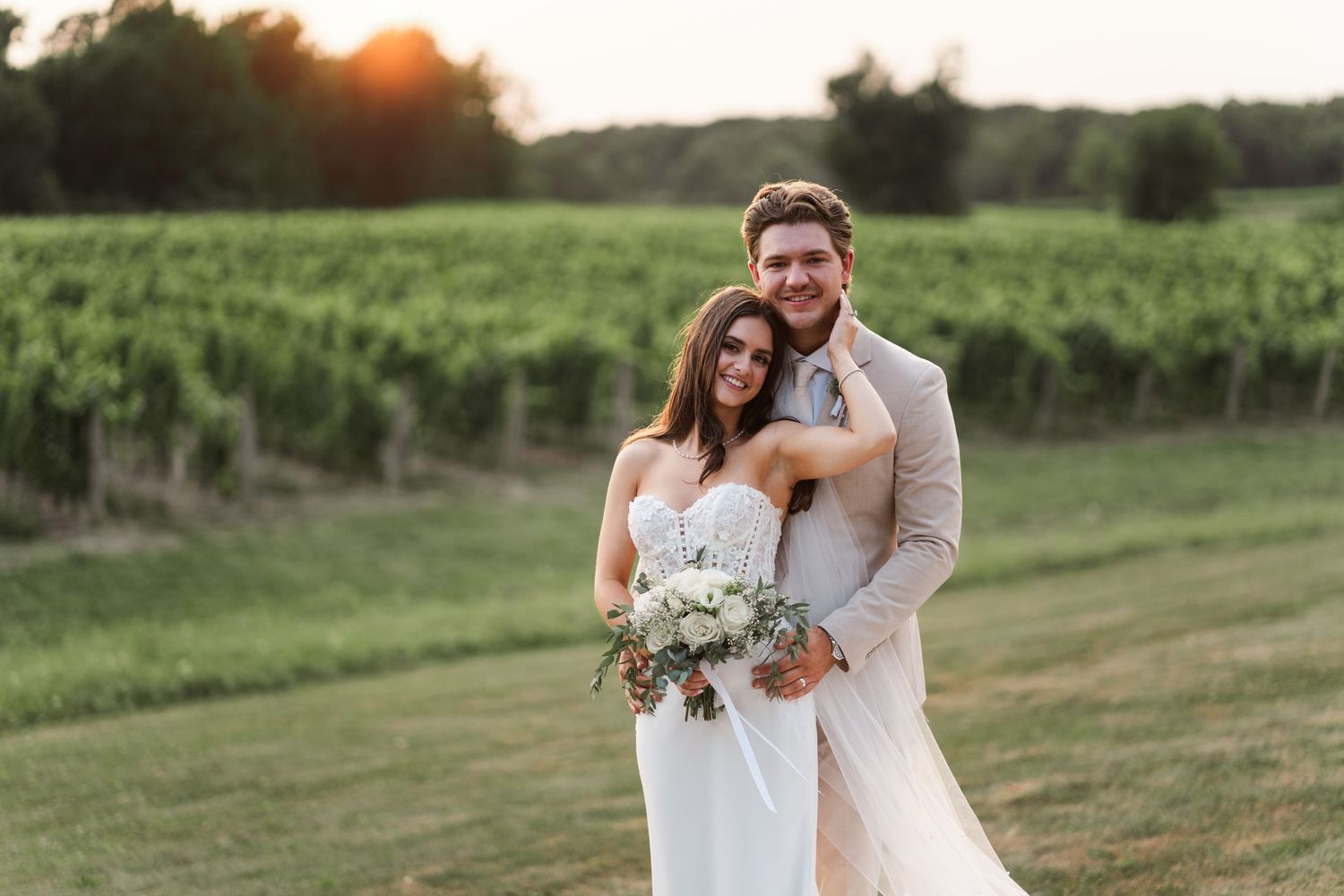 Romantic sunset portrait in vineyard with elegant floral bouquet.
Niagara wedding photos.