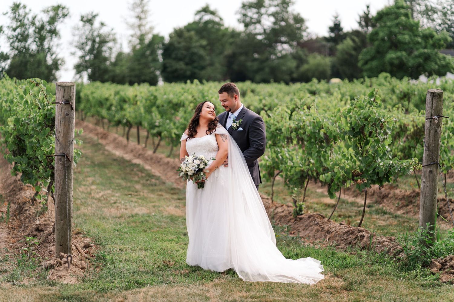 Elegant wedding photos taken in a scenic vineyard with rows of grapevines.
Niagara wedding photos.
