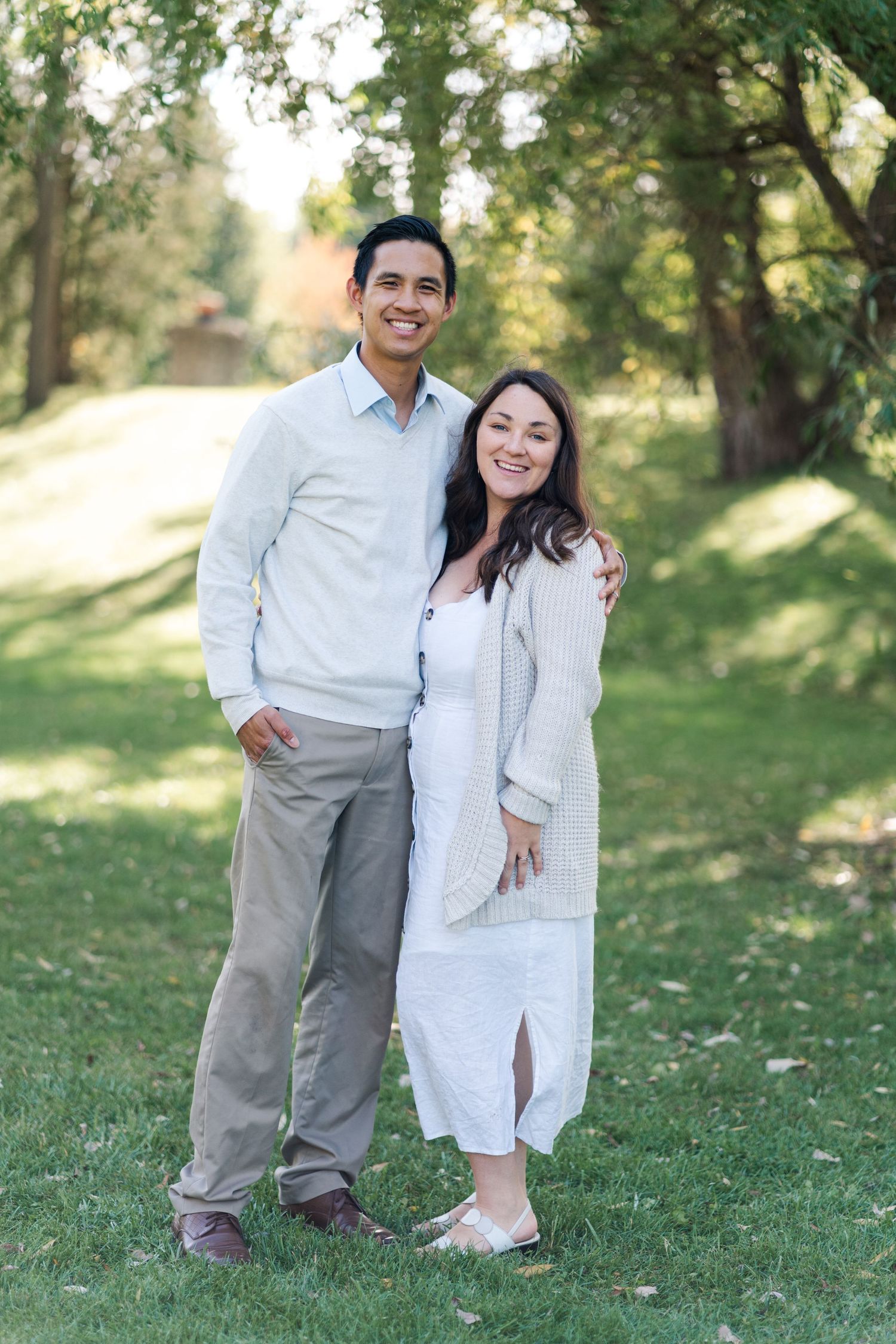 Couple posing together on grass during outdoor portrait session.
Niagara family photos.