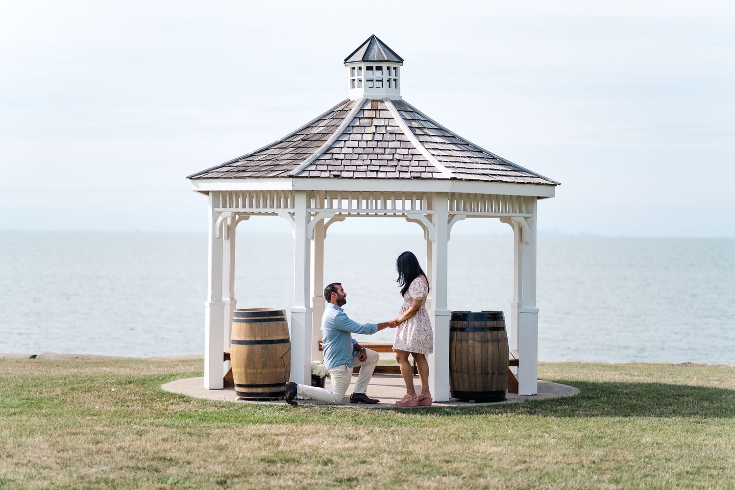 A seaside proposal in a white wooden gazebo overlooking the ocean.Niagara proposal photos.
