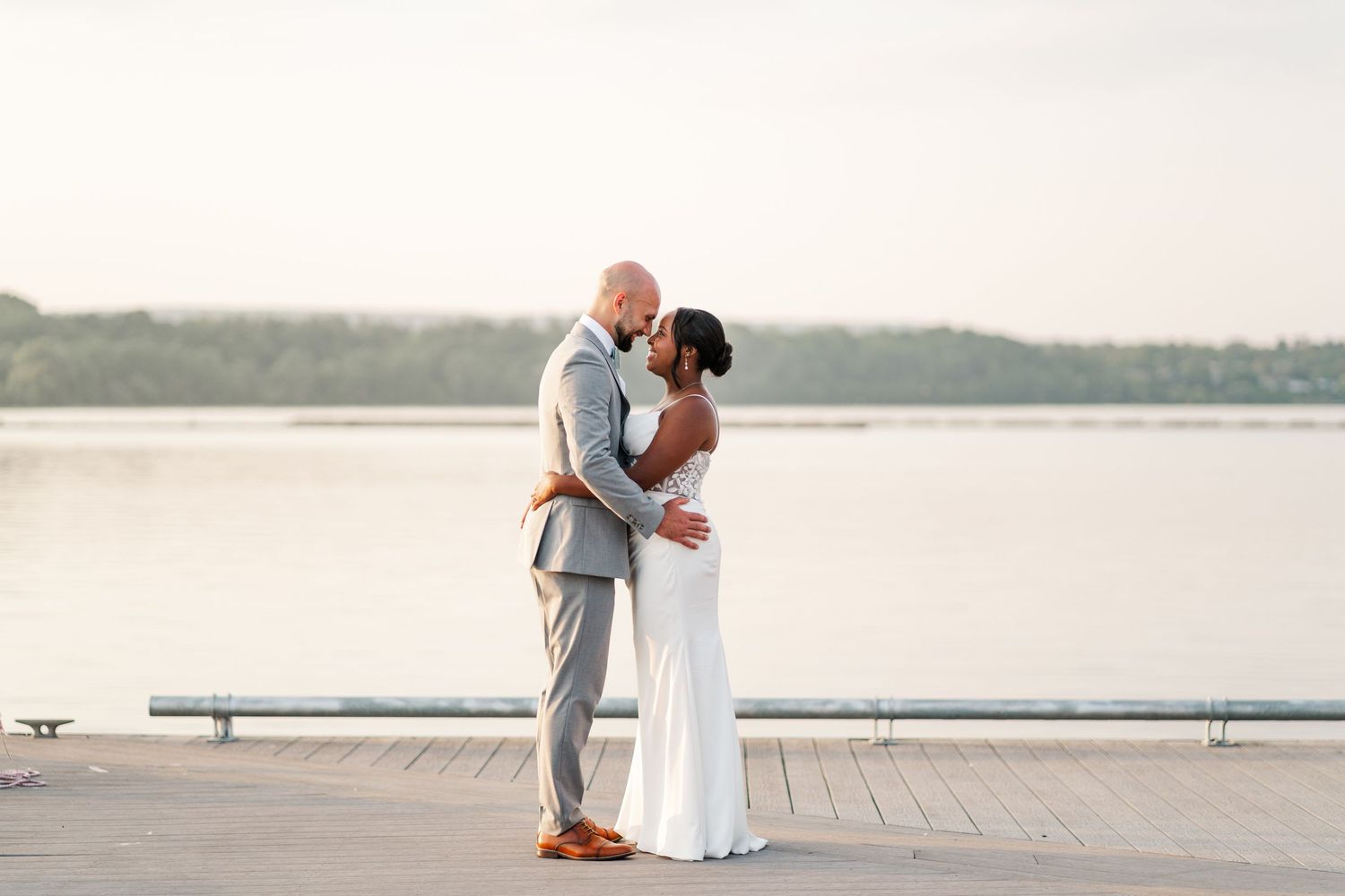 Elegant wedding couple walking along a serene waterfront boardwalk.
Niagara wedding photos.