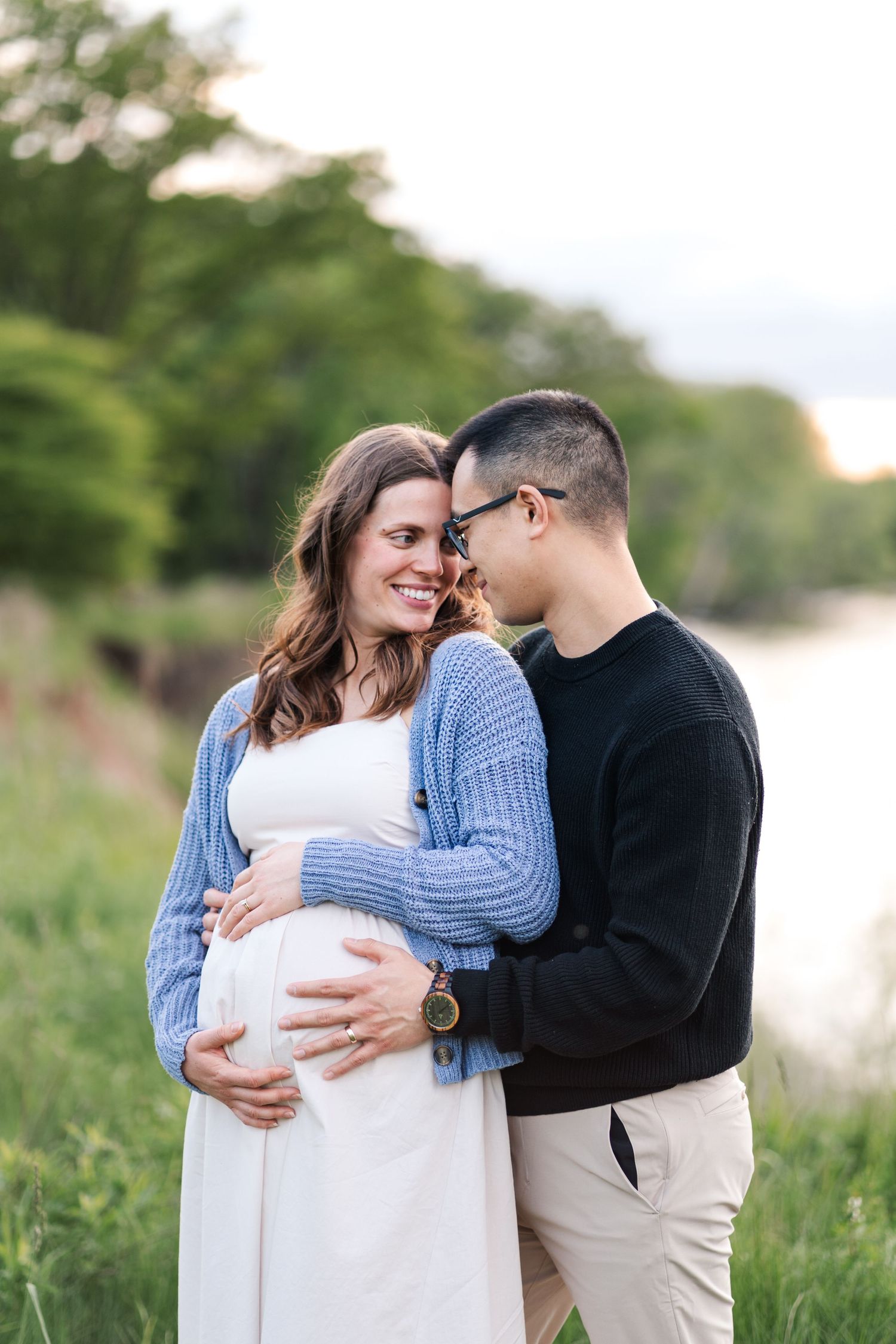 Intimate maternity photo of couple embracing by waterfront at sunset.
Maternity Niagara Photos.