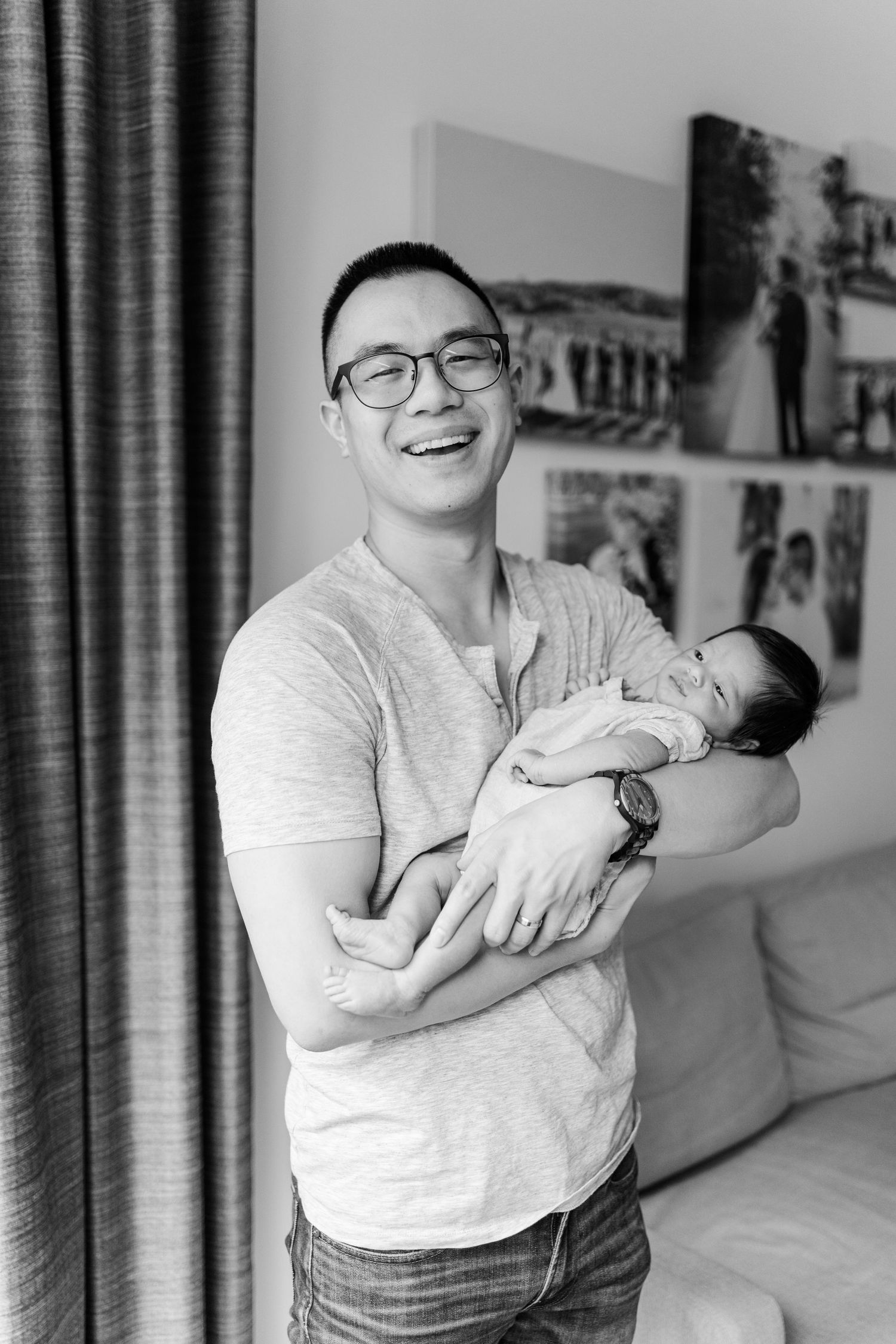 Black and white photo of joyful moments with a newborn at home.
Niagara newborn photos.