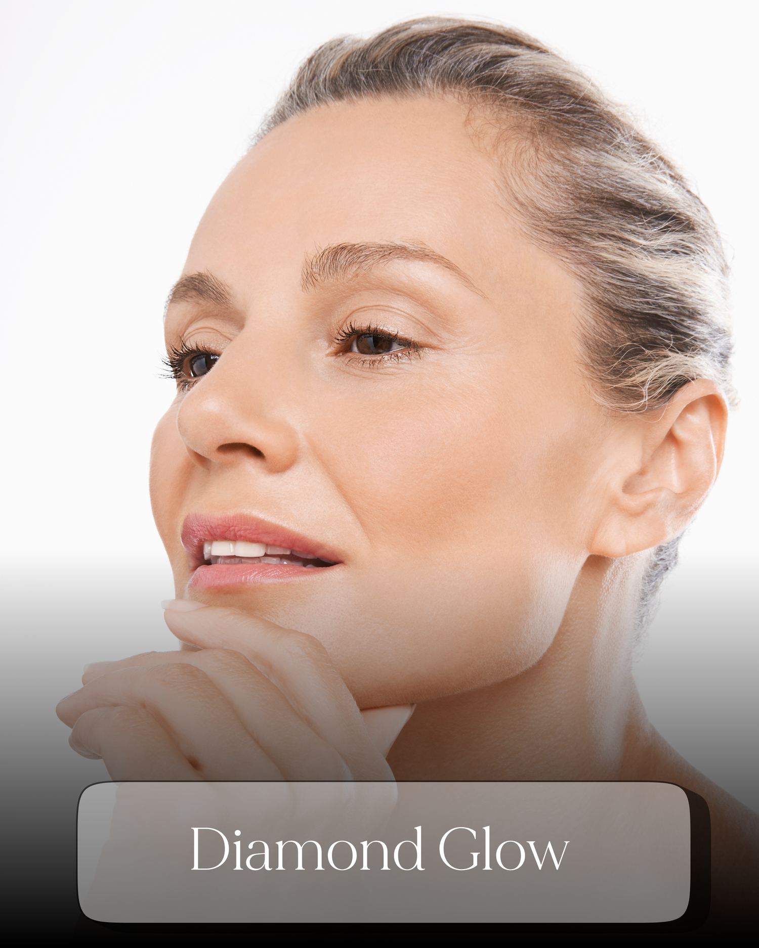 Elegant mature woman with radiant skin highlighting Diamond Glow facial treatment at Glow Med Spa.