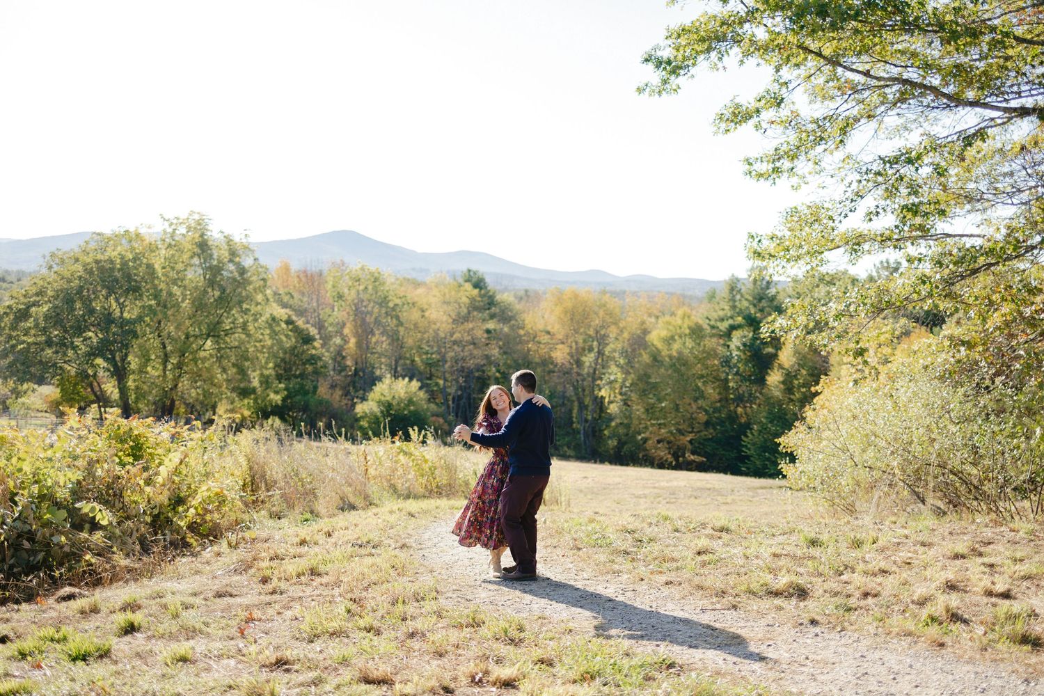 Landscape portrait of husband and wife dancing outdoors