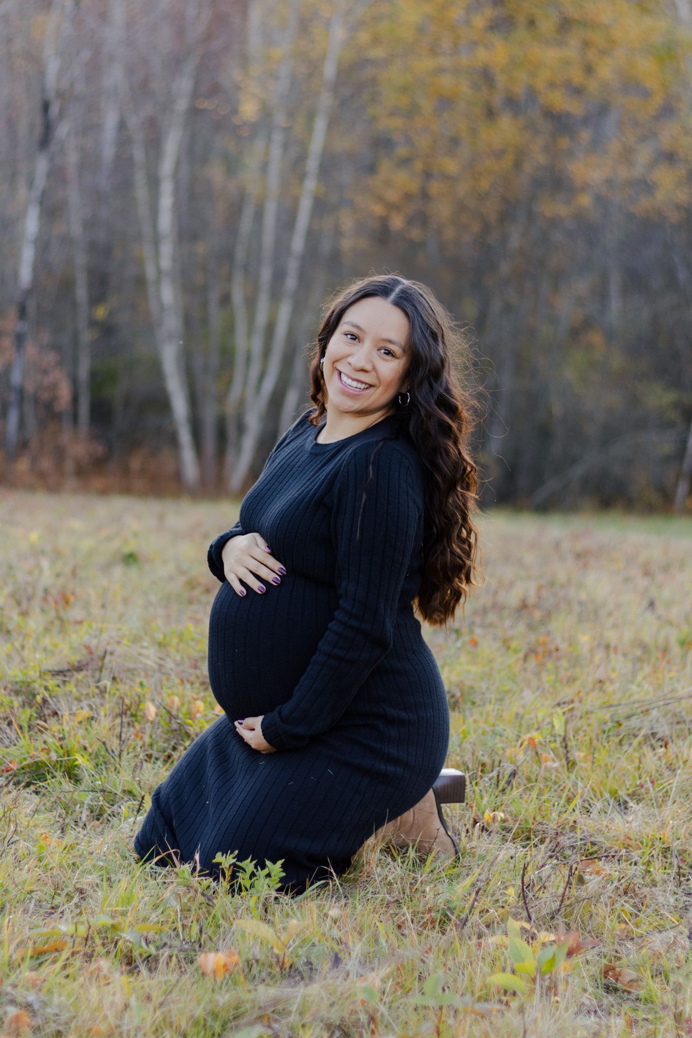 Outdoor portrait of pregnant woman in field