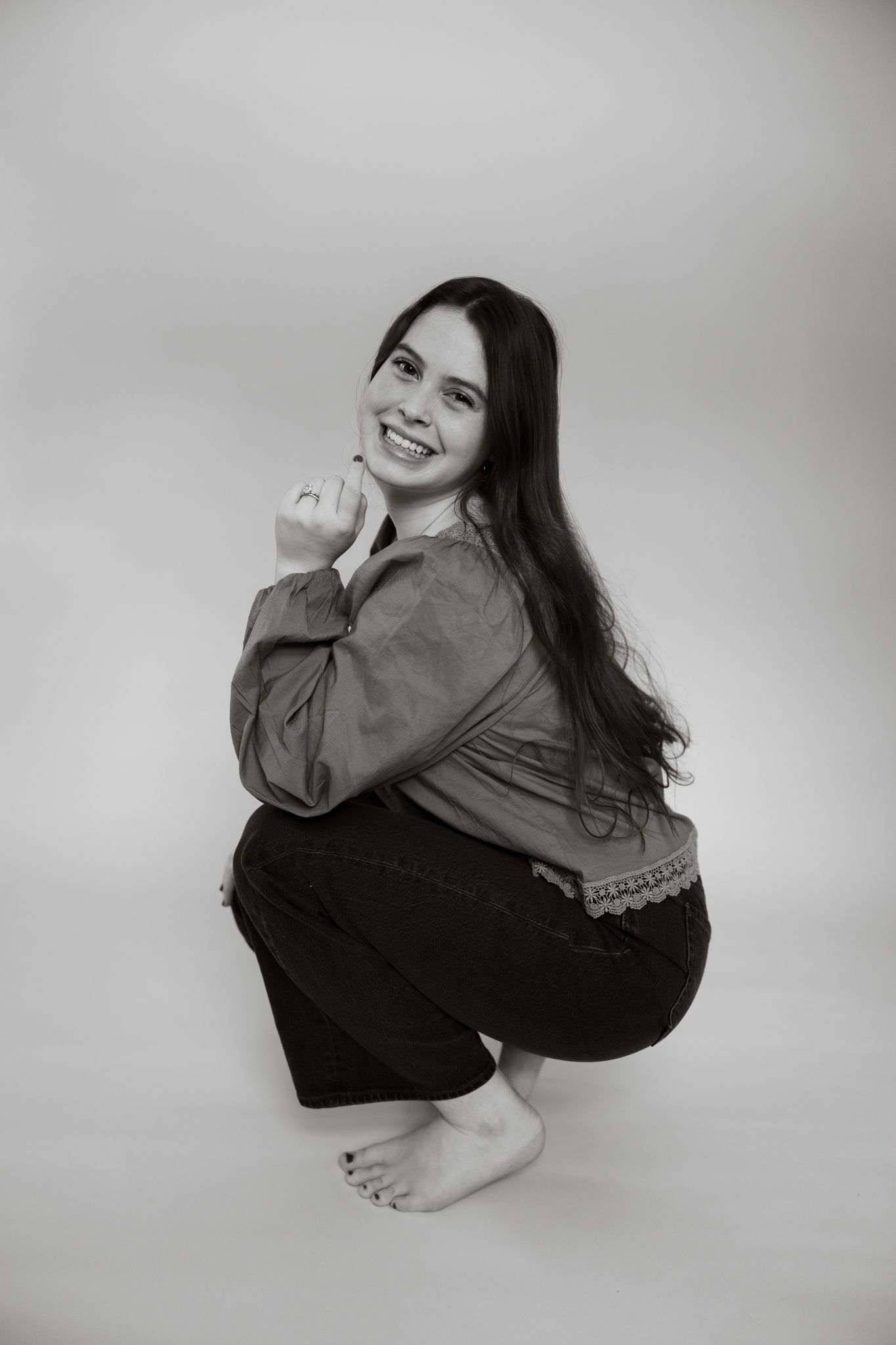 Series of black and white portraits showing playful poses in casual attire.