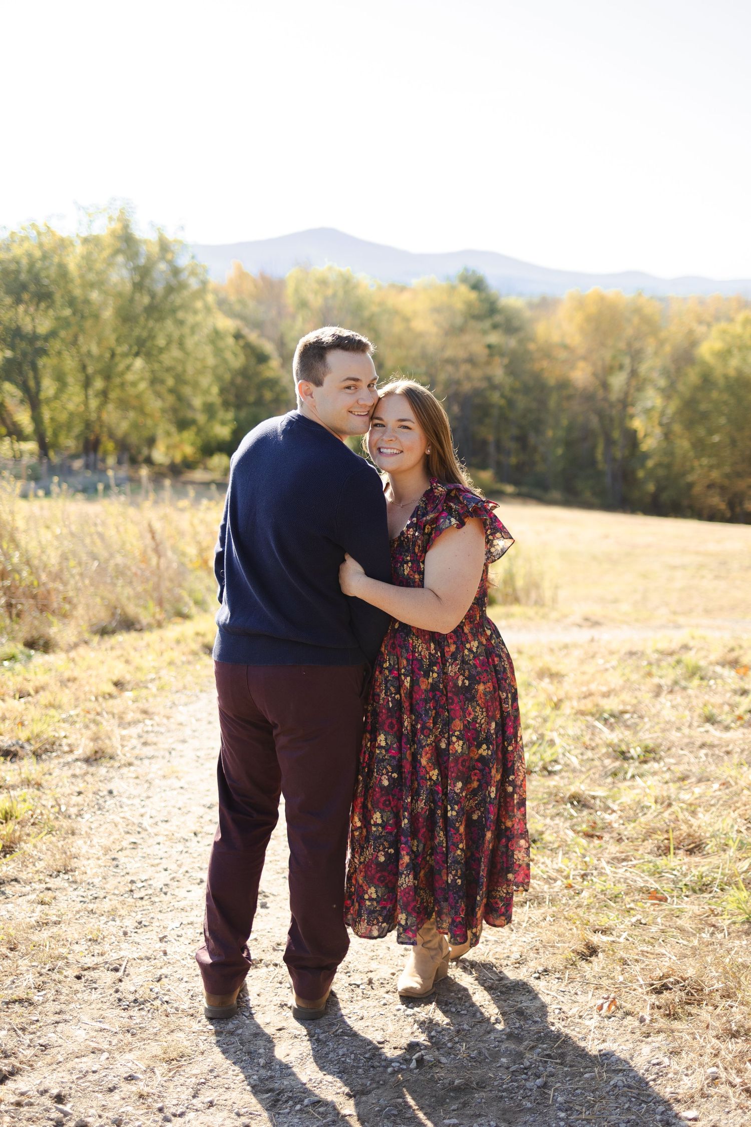 Image of husband and wife hugging outside