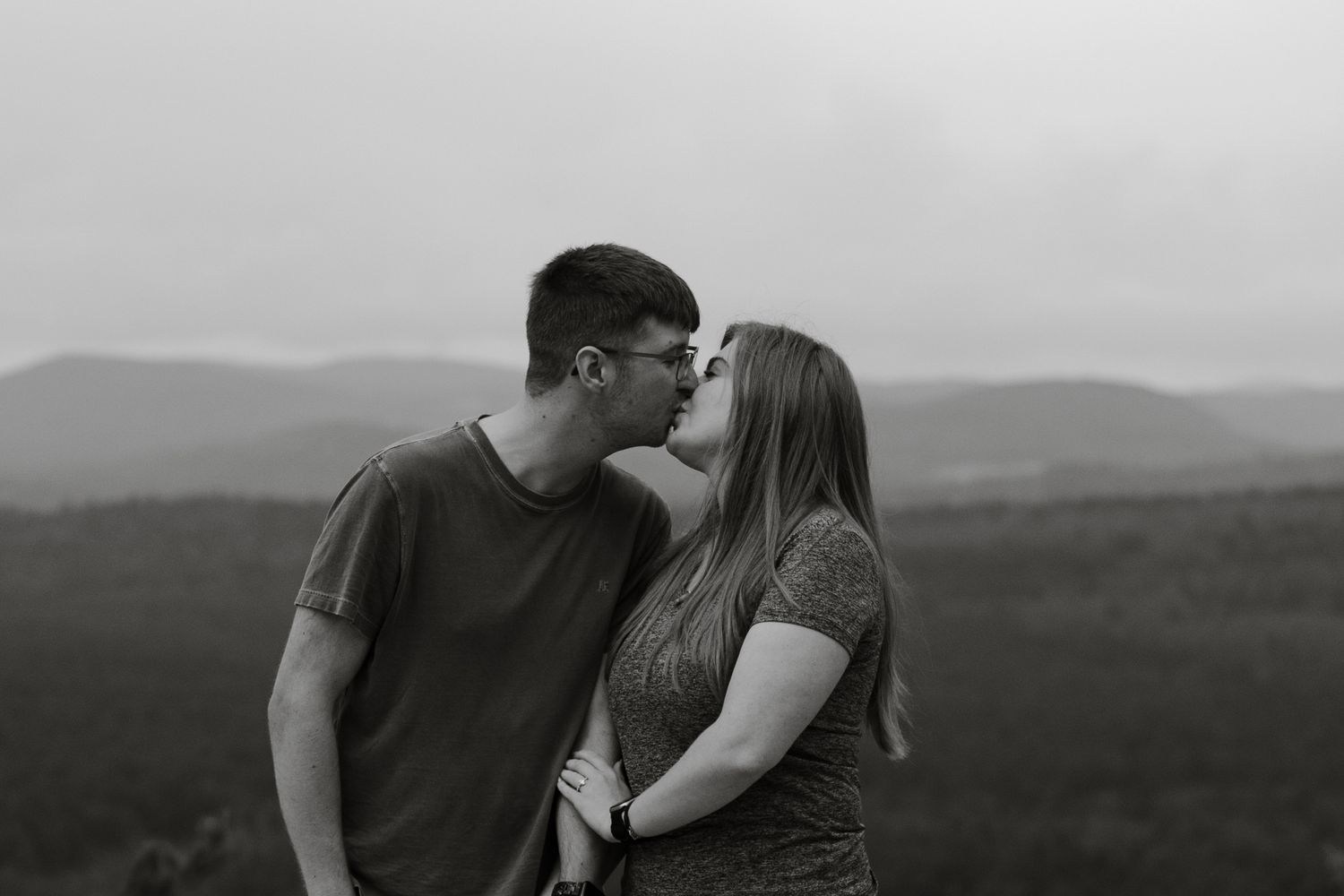Photo of couple kissing after getting engaged