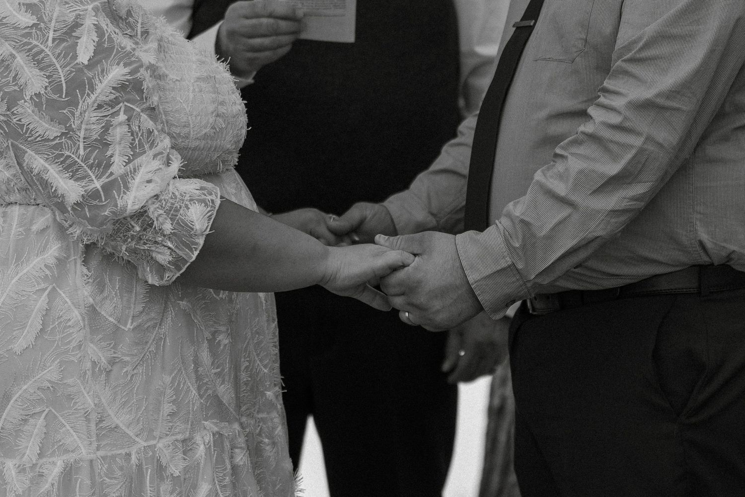 image of bride and groom holding hands on wedding day