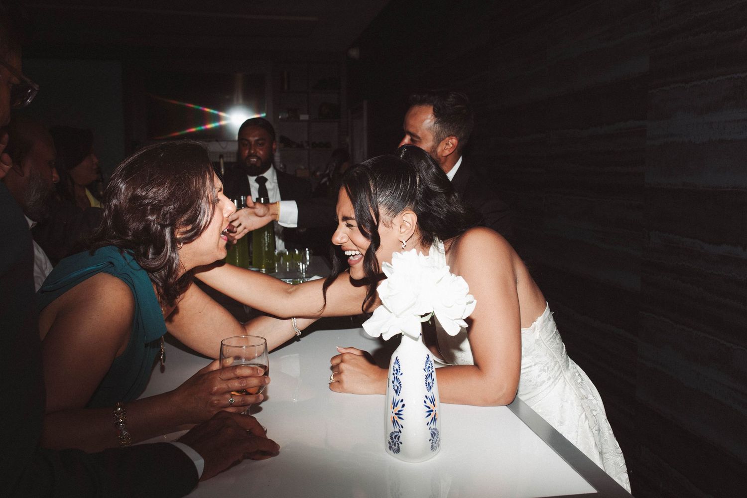 A series of dark party photos showing people dancing and socializing at what appears to be a wedding reception or celebration.