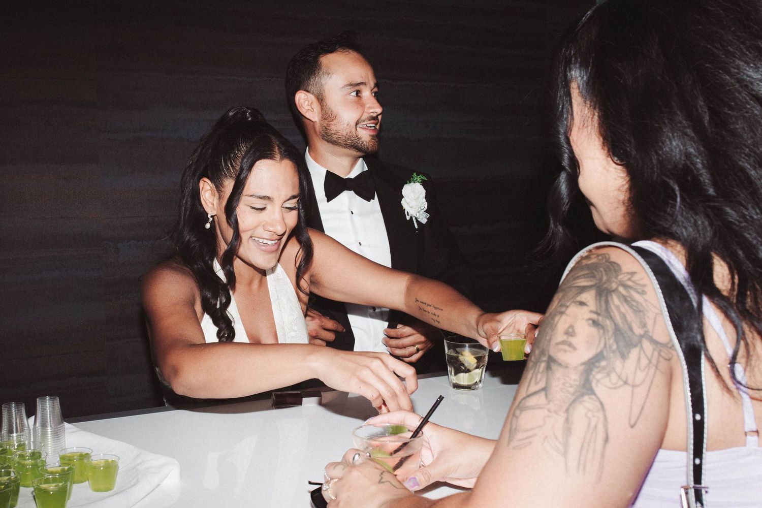 A couple shares an intimate moment at a dimly lit restaurant table during dinner service.