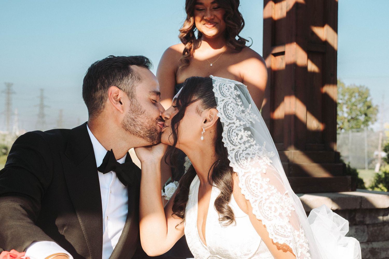 Romantic wedding couple shares intimate kisses in a series of black and white and color photographs outdoors.