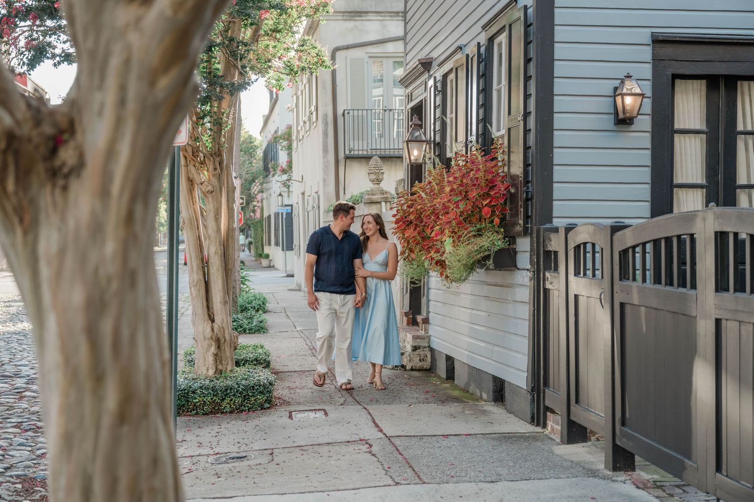 Historic neighborhood street with blue buildings and charming architectural details.