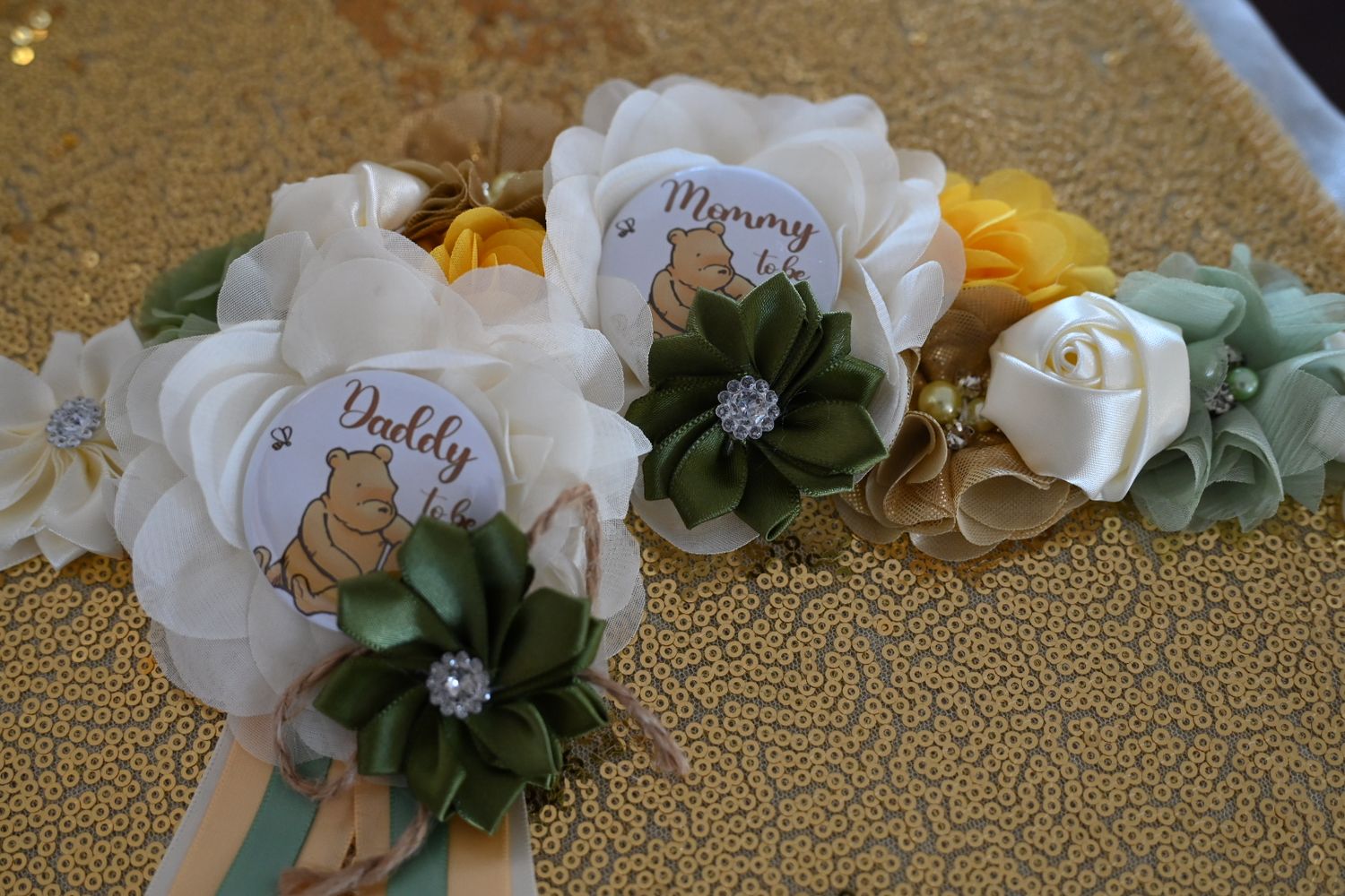 Winnie the Pooh themed Mommy and Daddy to be baby shower corsages with fabric flowers.