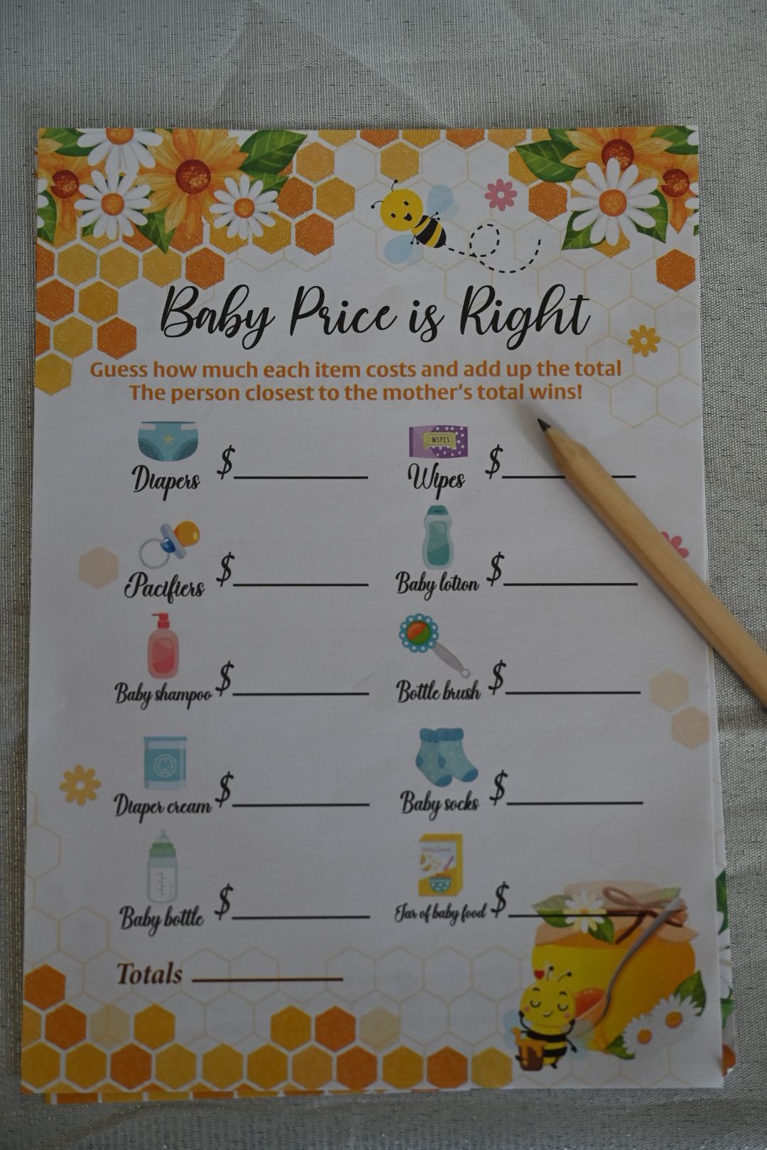 Bee-themed Baby Price is Right baby shower game card listing baby items with price blanks.