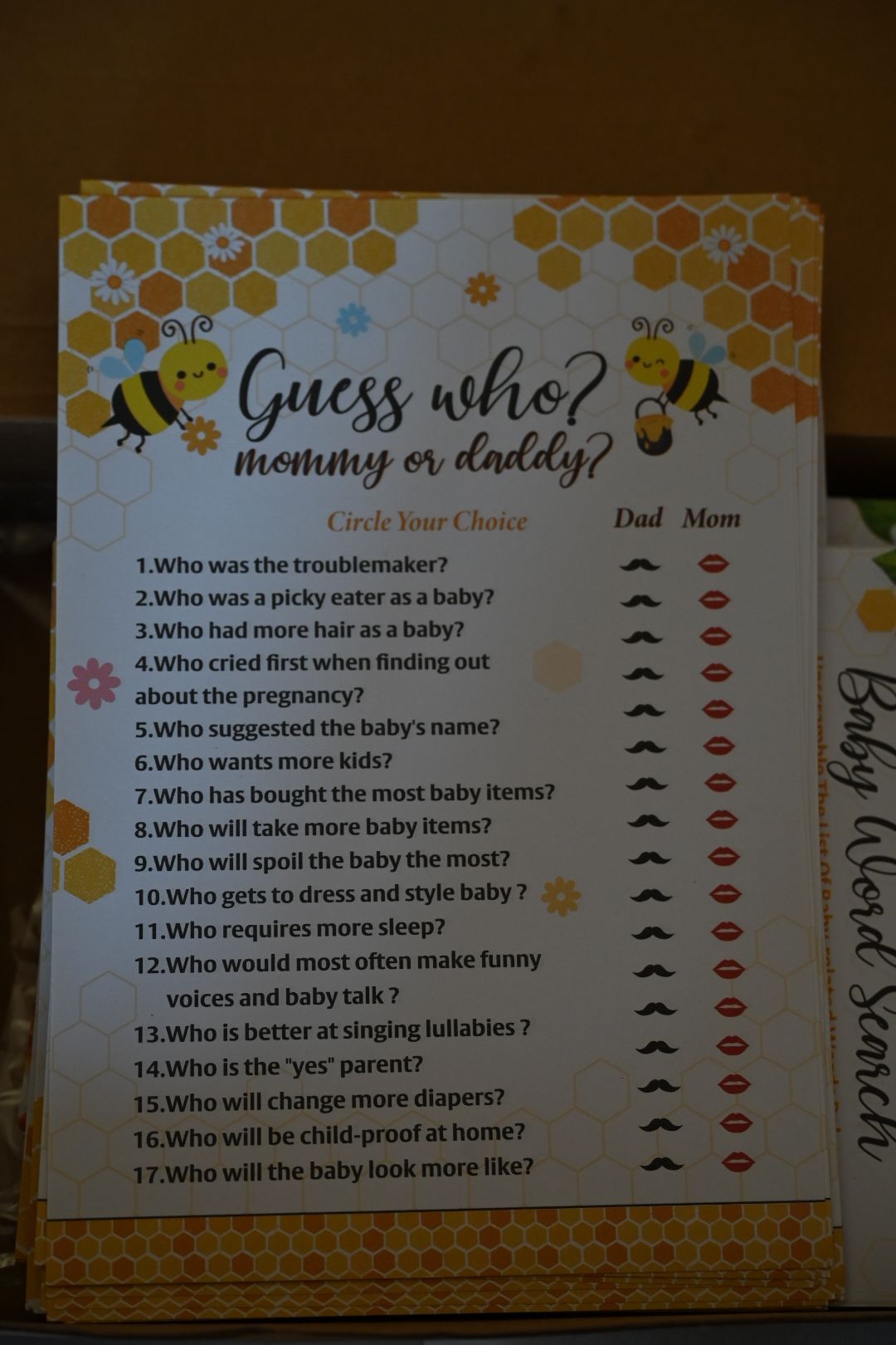 Bee-themed Guess Who Mommy or Daddy baby shower game card with mustache and lips choices.