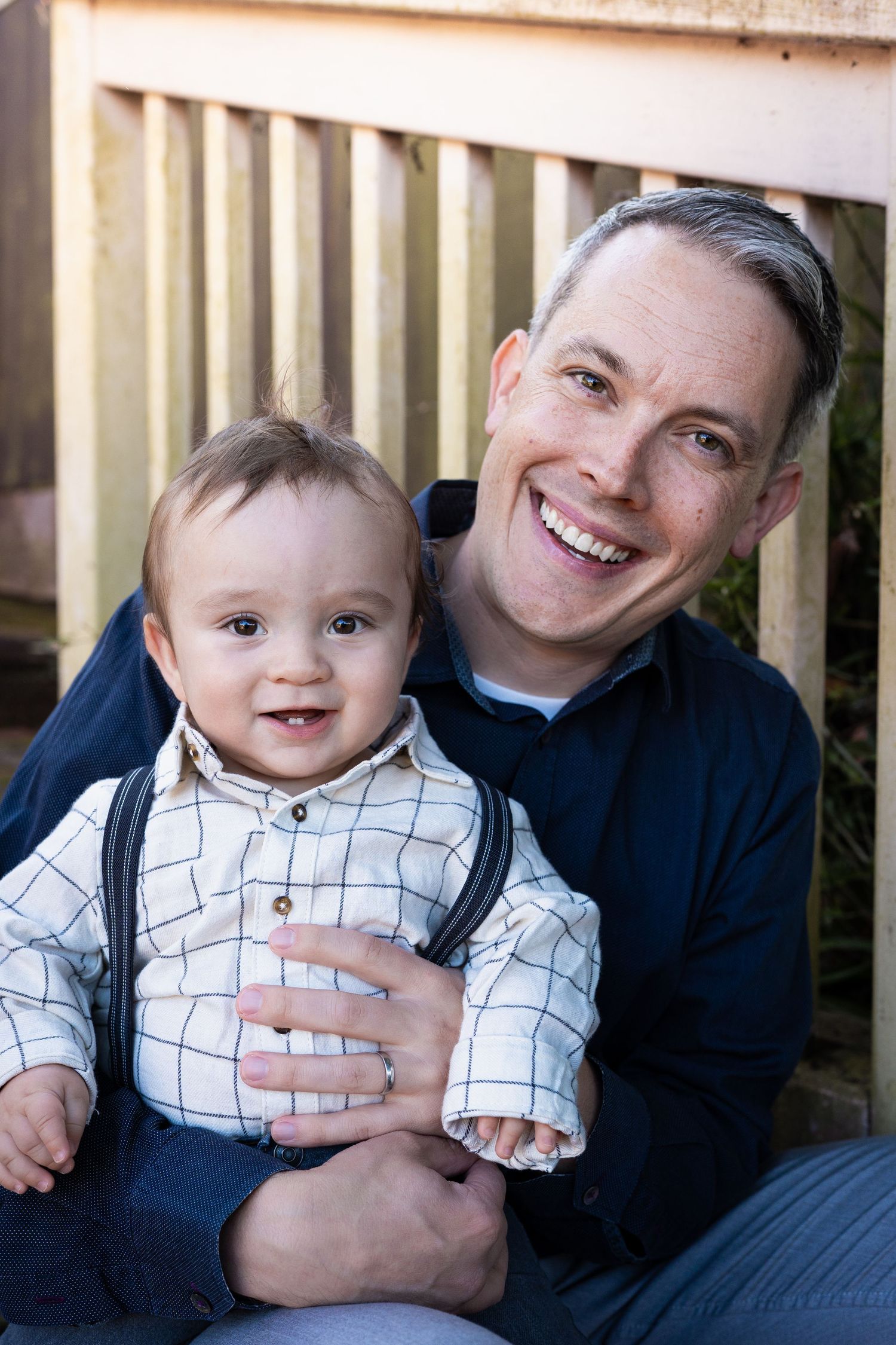 A series of four connected photos showing joyful interaction between adult and child on wooden deck.