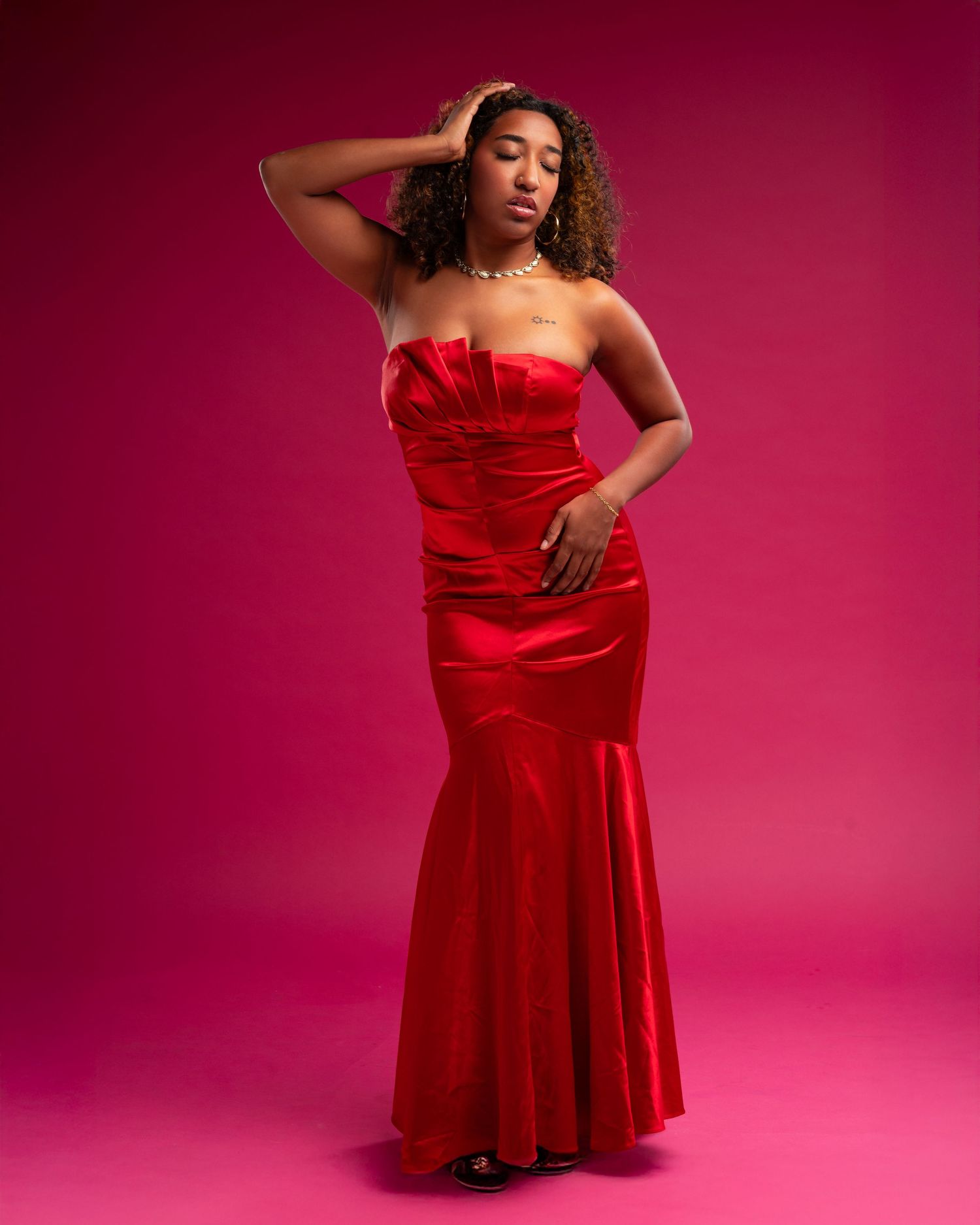 A figure in a vibrant red dress poses gracefully against a pink studio backdrop in a series of dynamic shots.