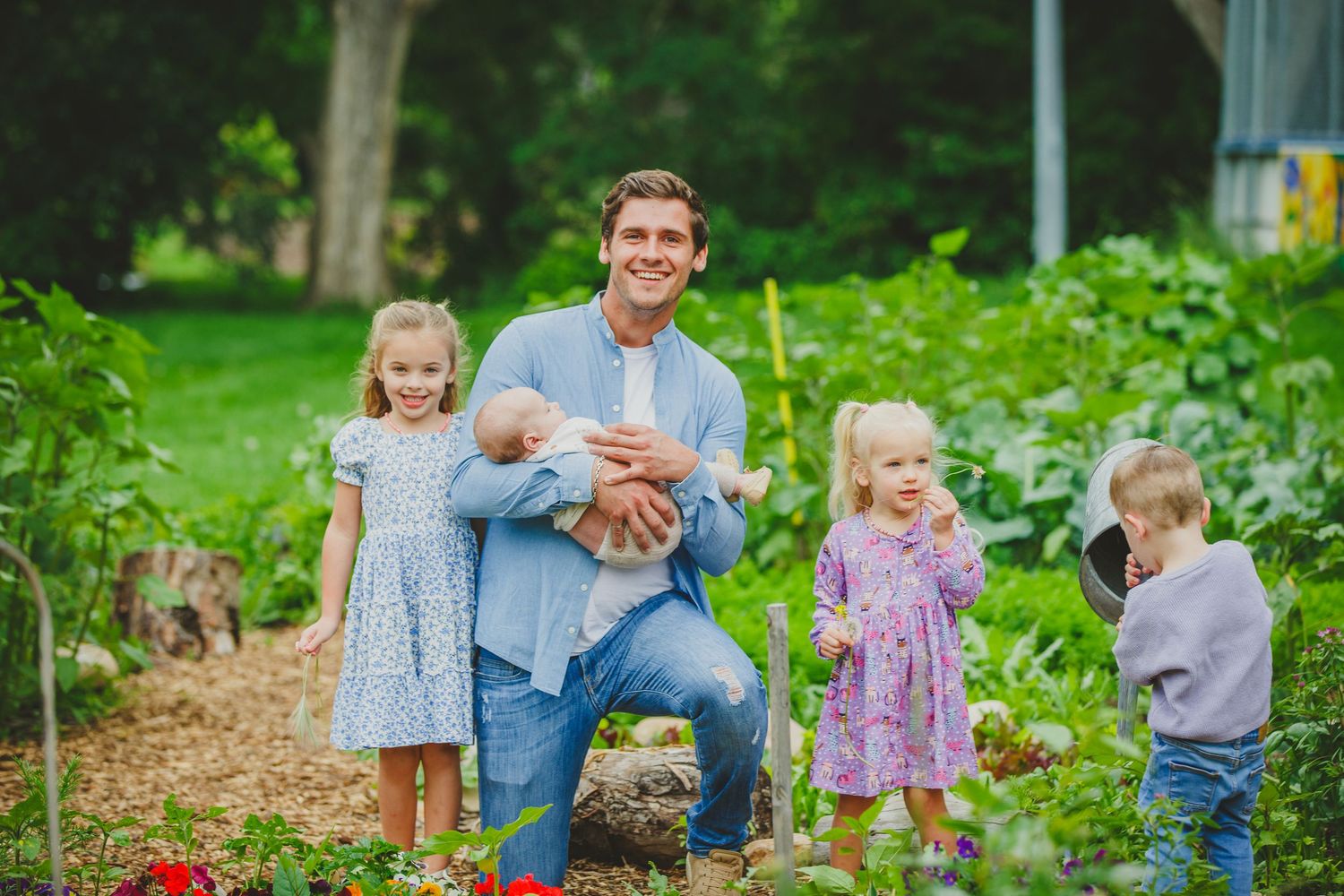 A family enjoys time together in a lush green garden setting during summer.
