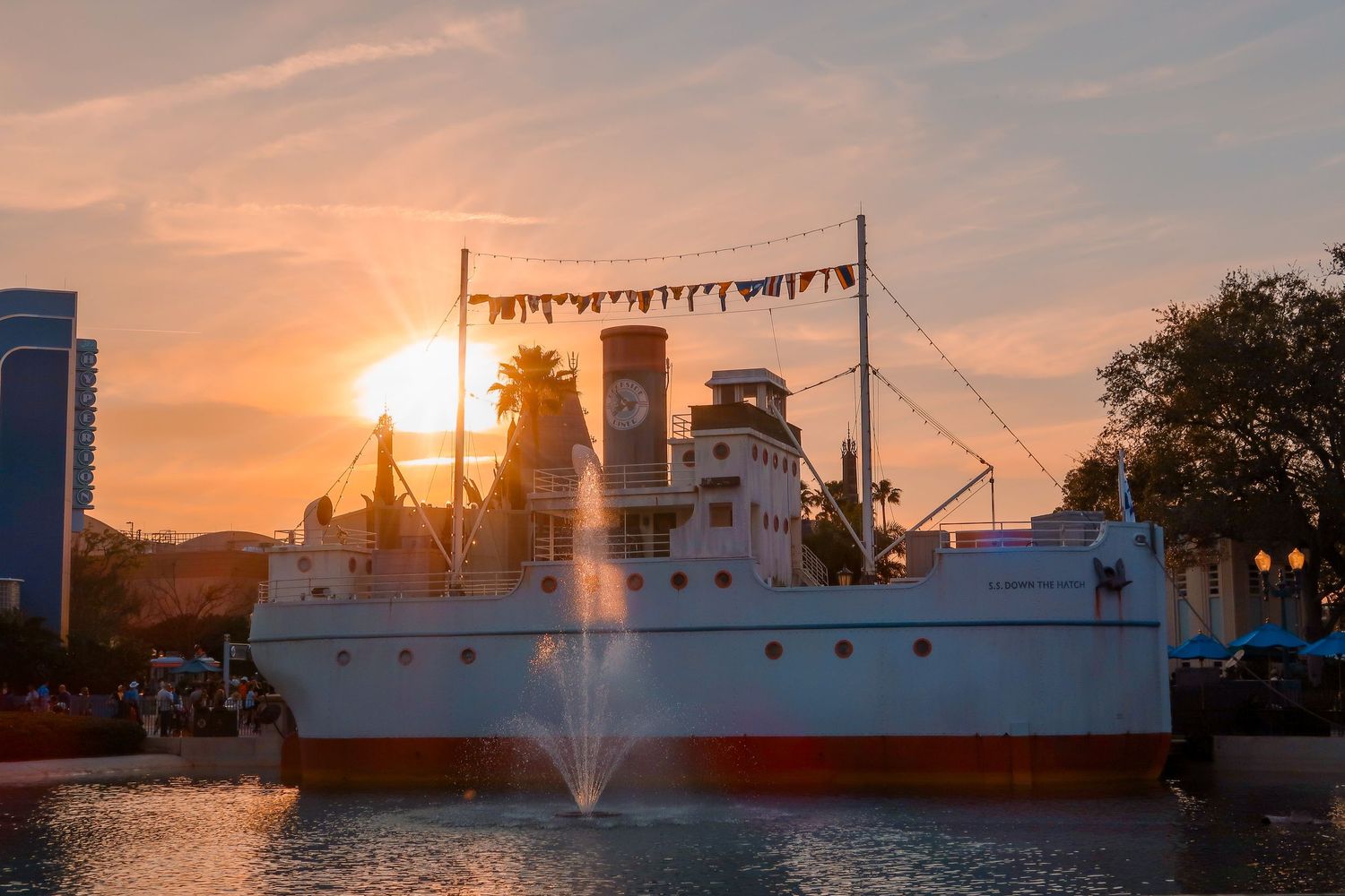 Vintage steamship with fountain at Disney's Hollywood Studios at golden sunset.
