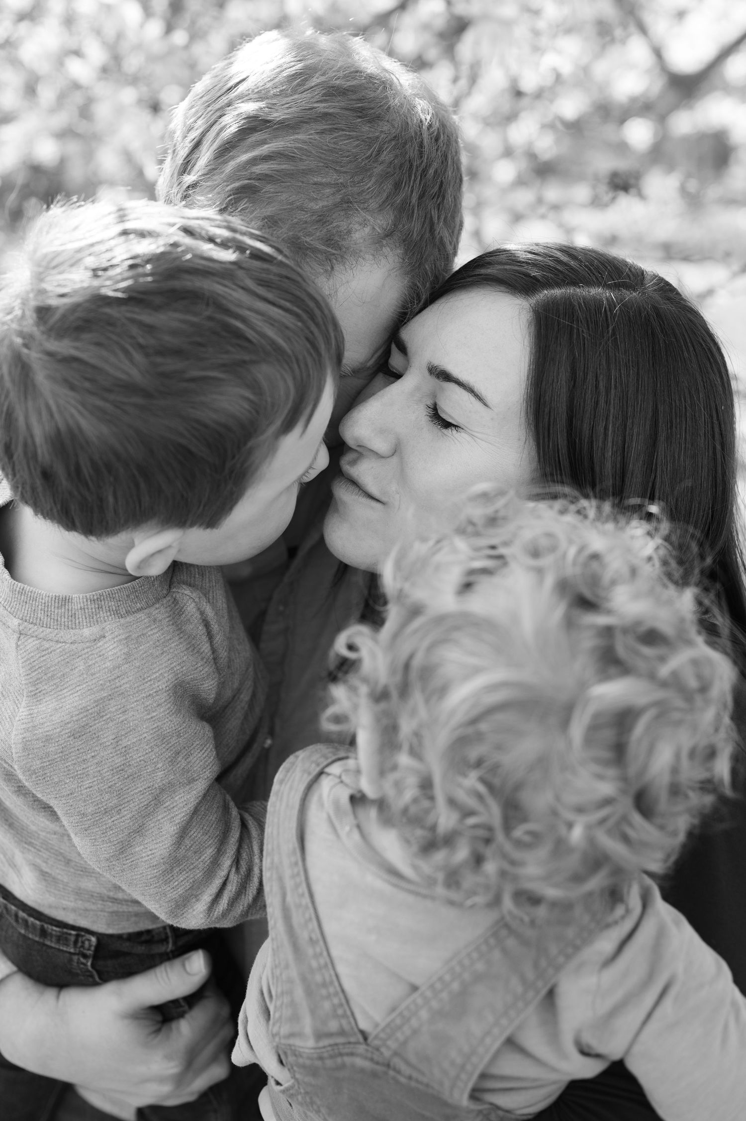 Tender family moment captured in black and white photography.