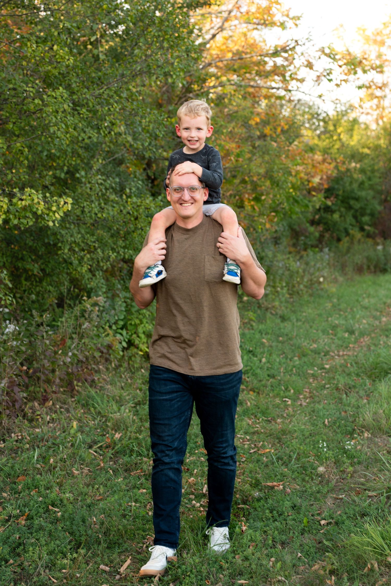 A playful series of outdoor portraits showing someone in a brown sweater and jeans against autumn foliage.