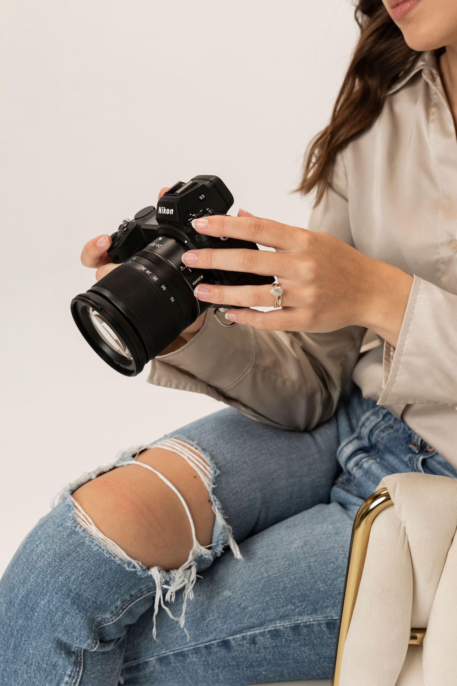 meet the photographer page - holding camera