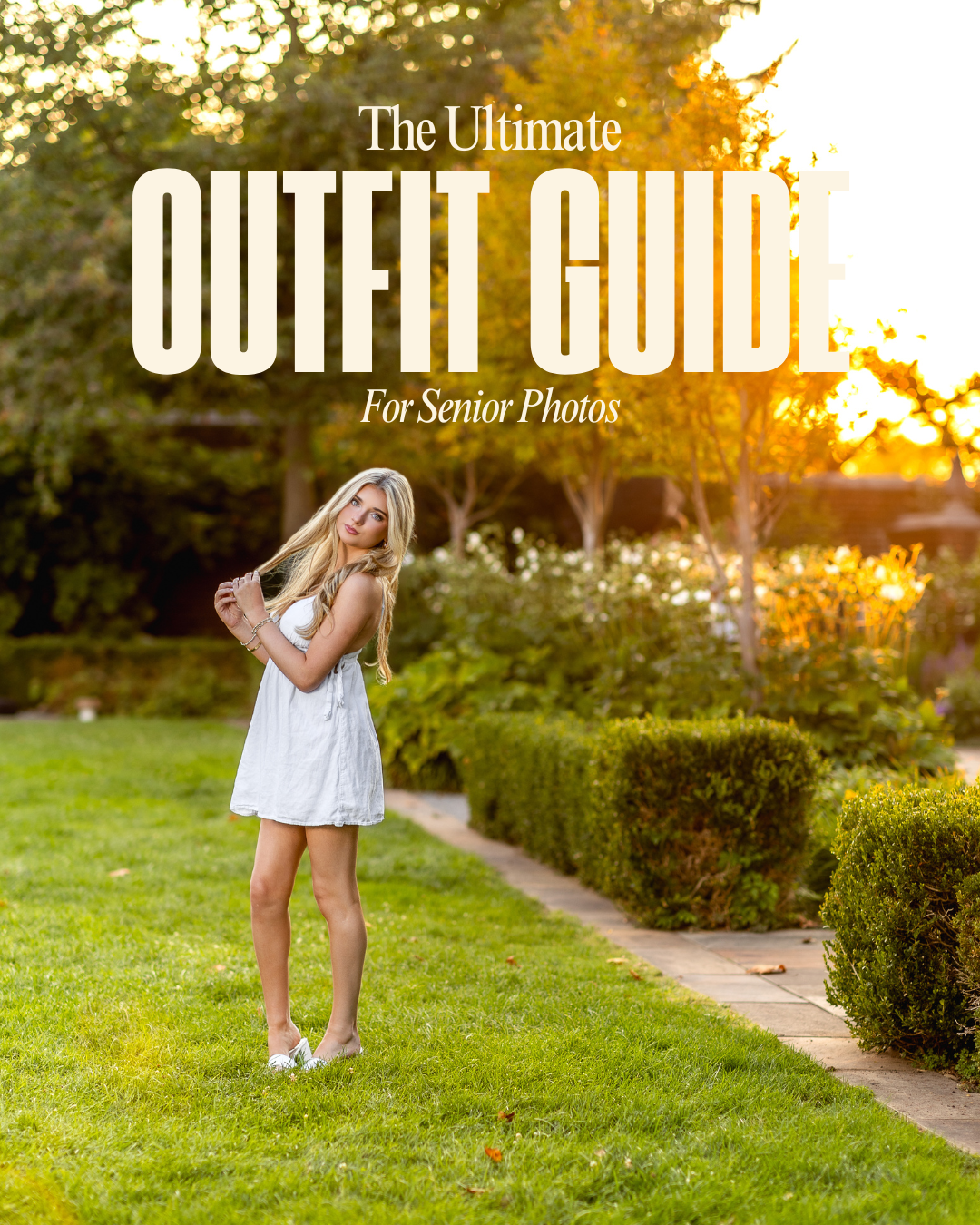 Blonde teen girl in white dress posing in a garden pathway for senior photos with the Ultimate Outfit Guide overlay.