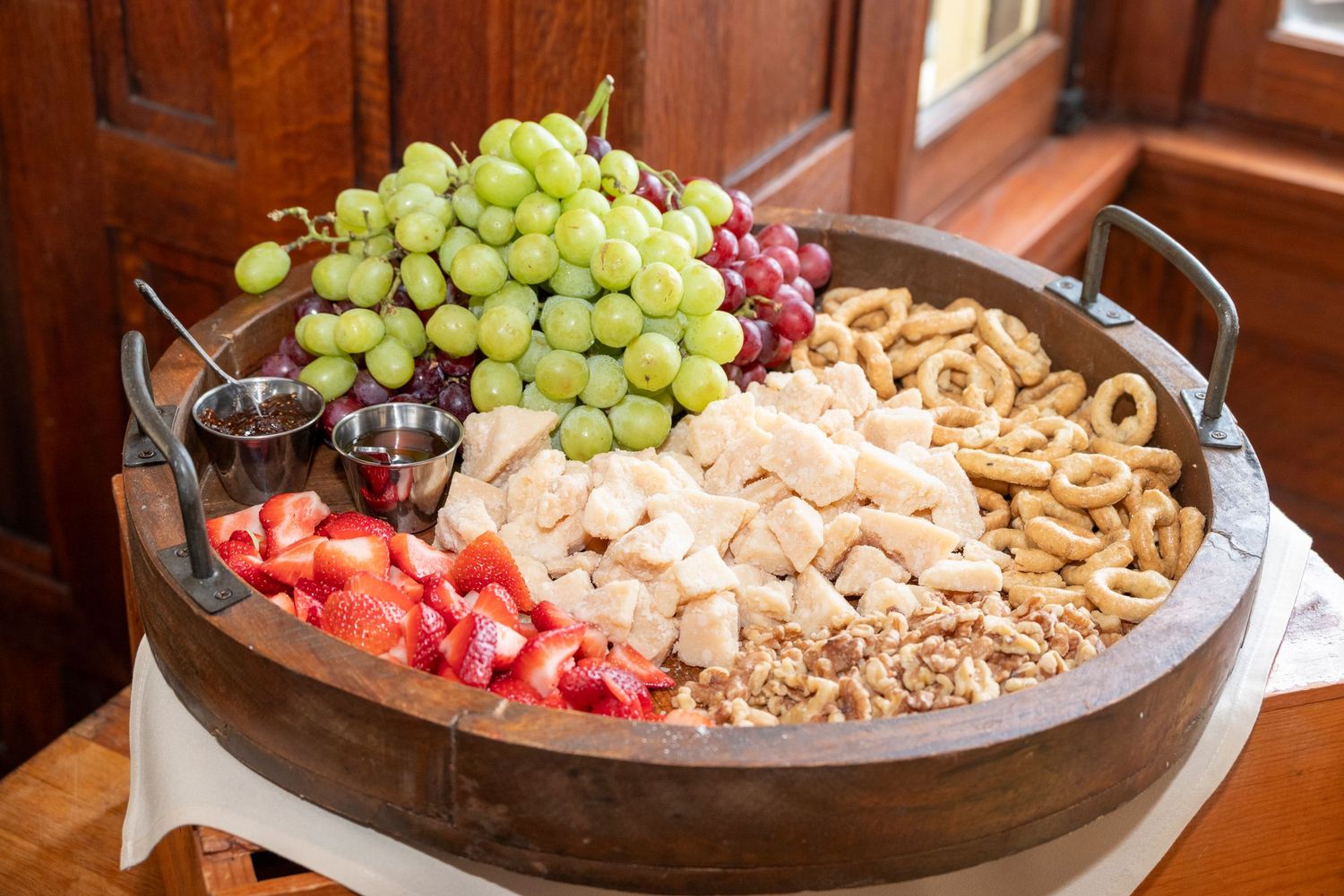 Charcuterie board with fruit and crackers at event