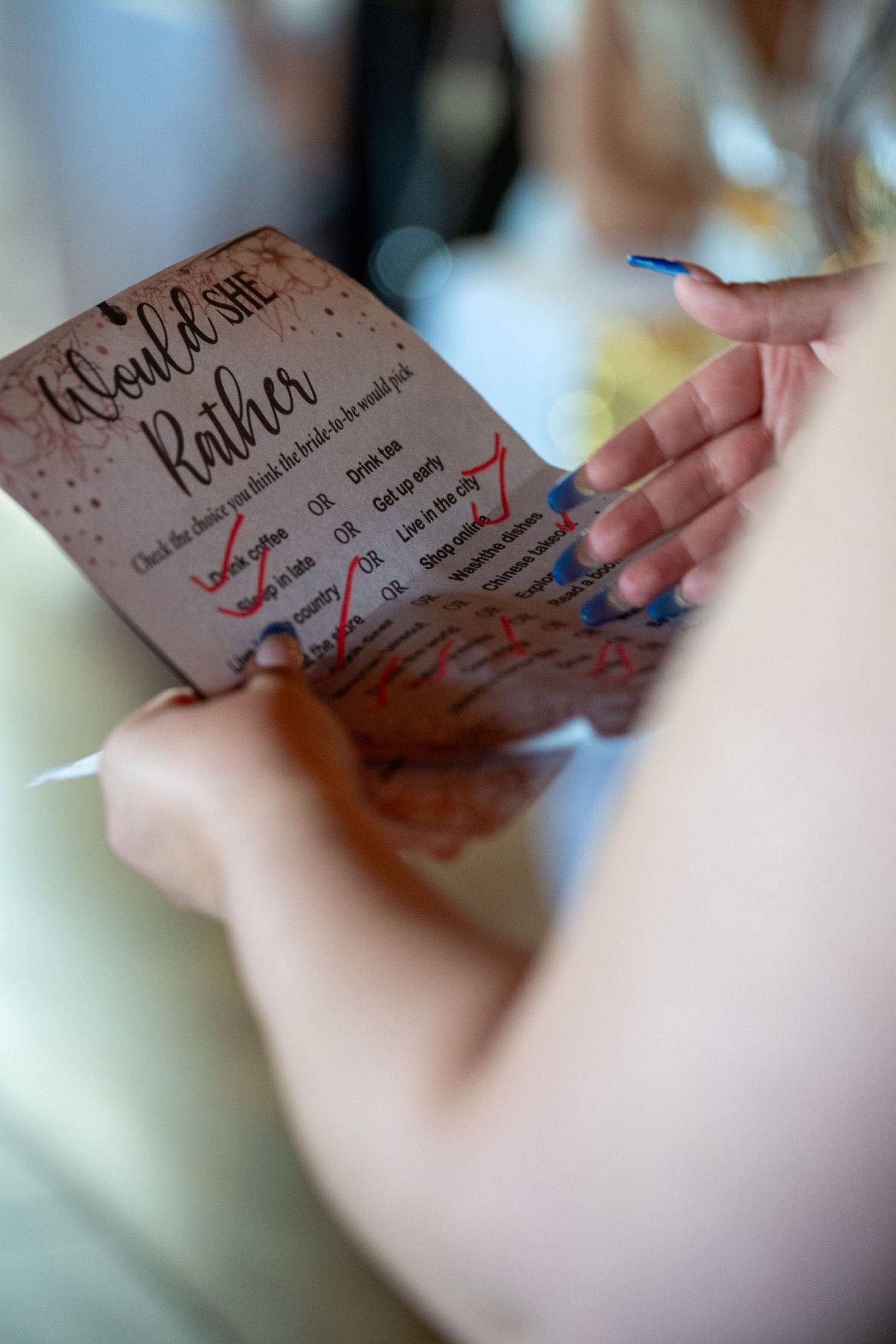Close-up of bridal shower invitation in guest’s hands