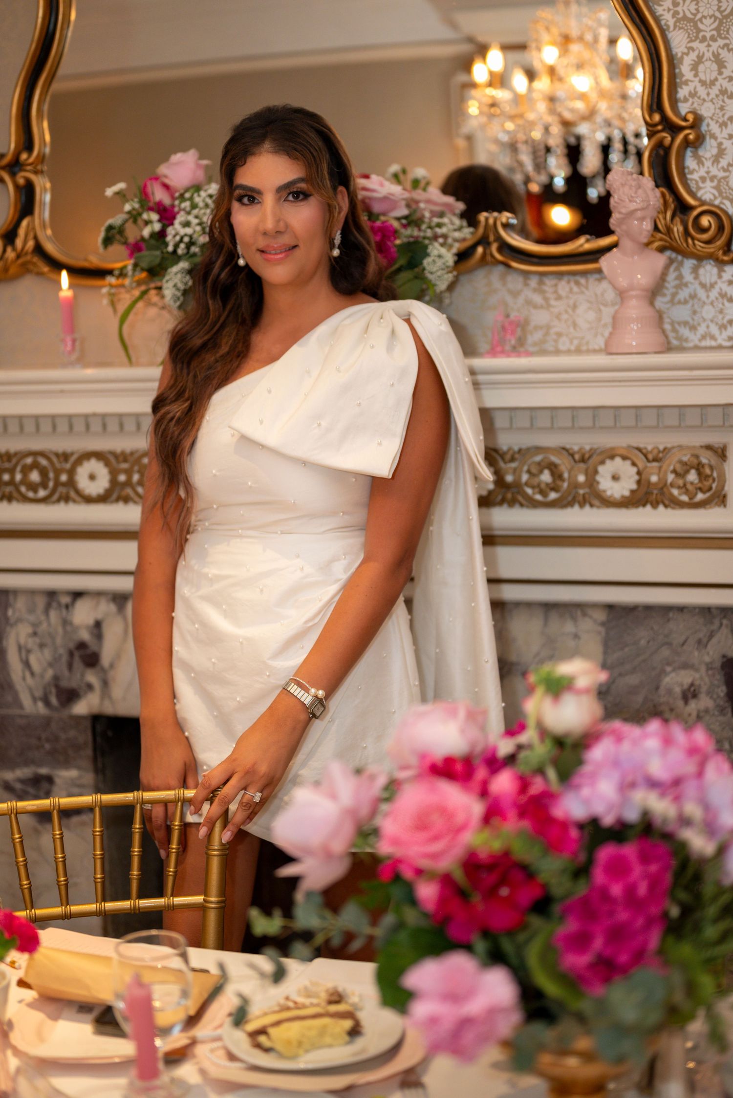 Bride-to-be posing with floral arrangement indoors