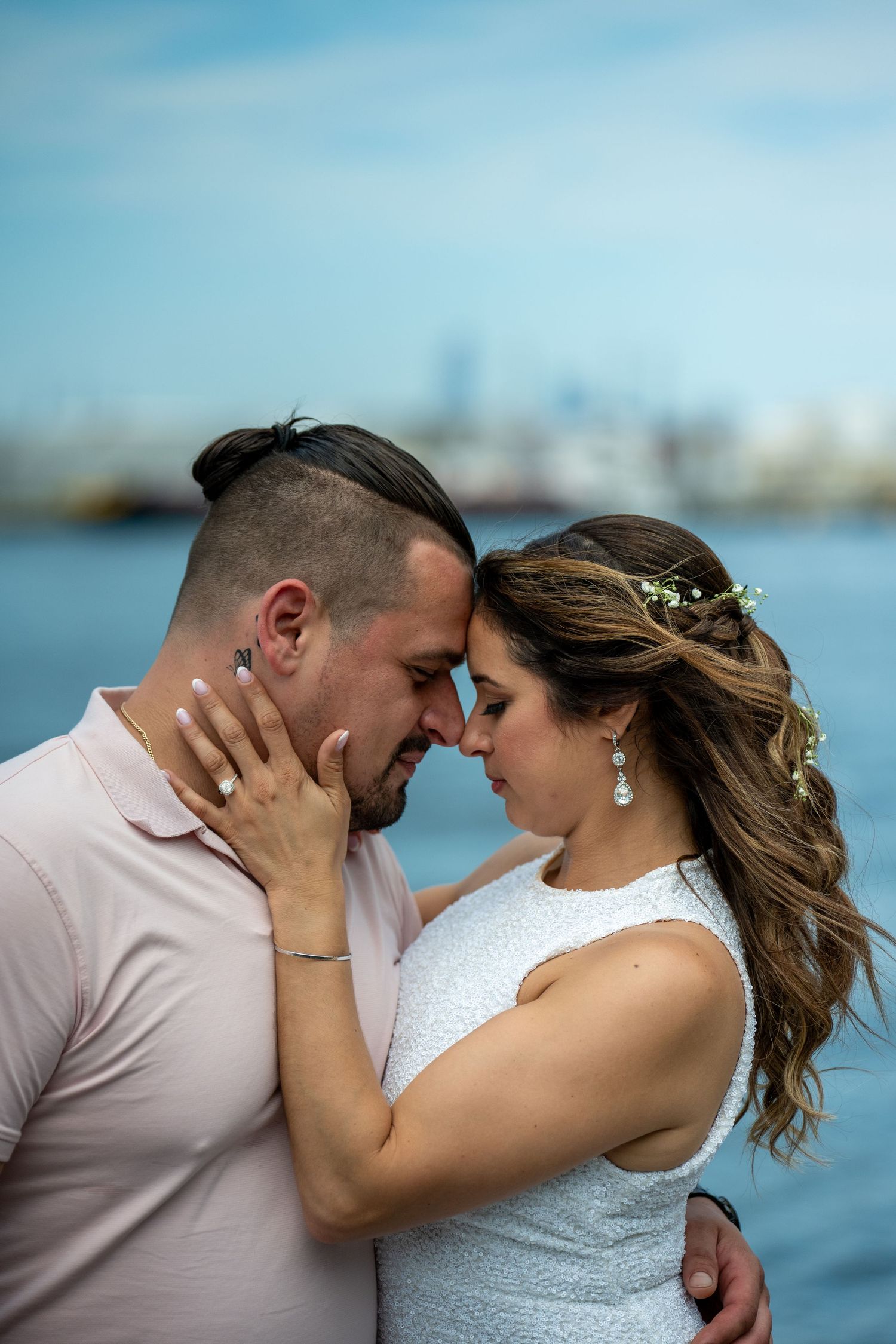 Romantic couple embracing at seaside engagement shoot