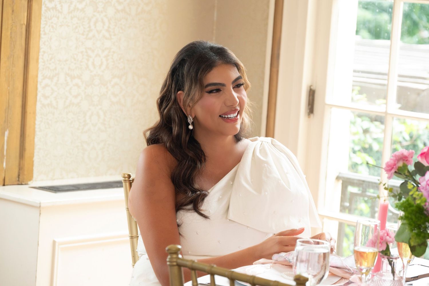 Bride-to-be smiling by window in natural light