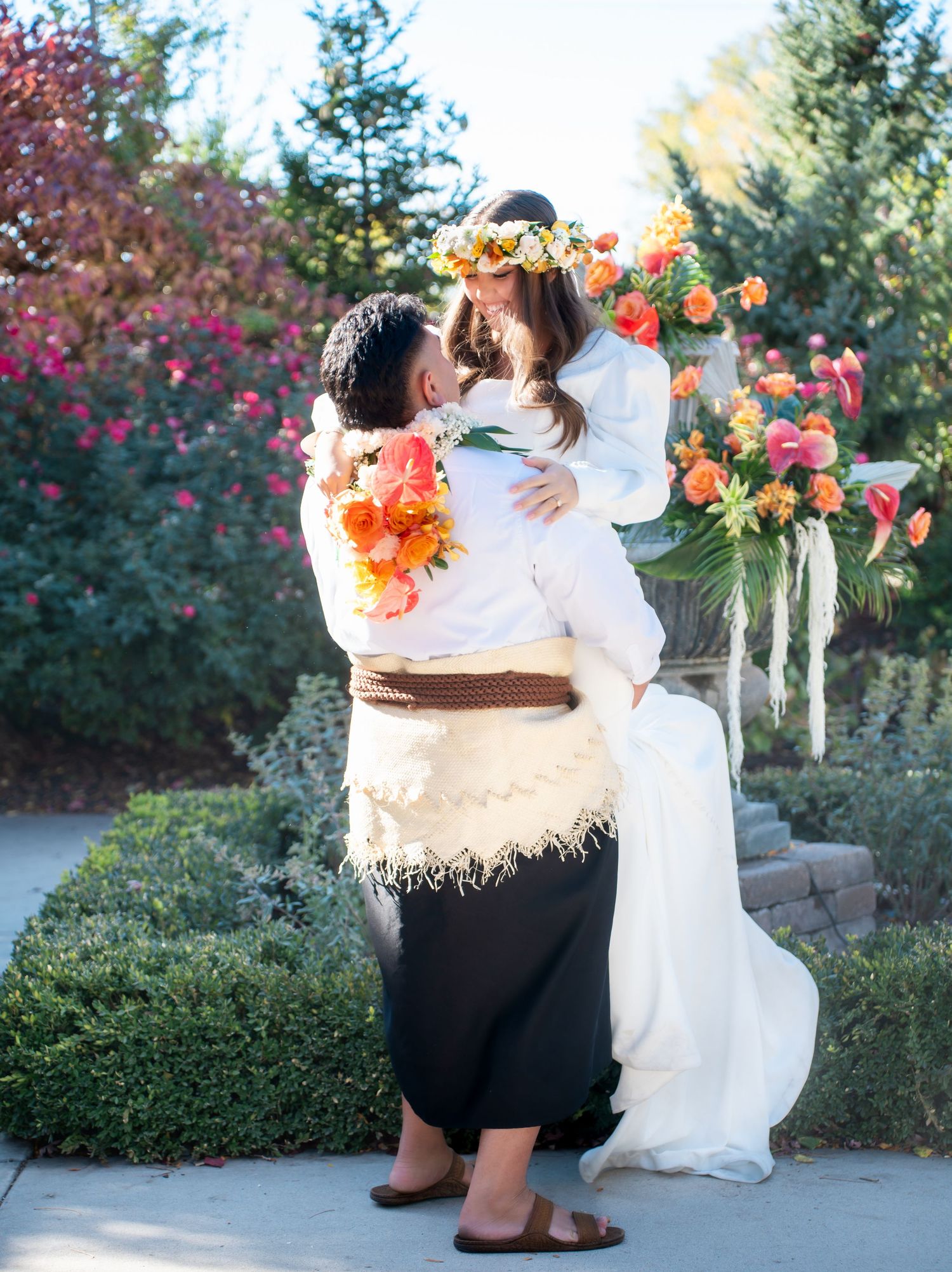 Romantic outdoor wedding moment captured in a garden setting with colorful flowers.