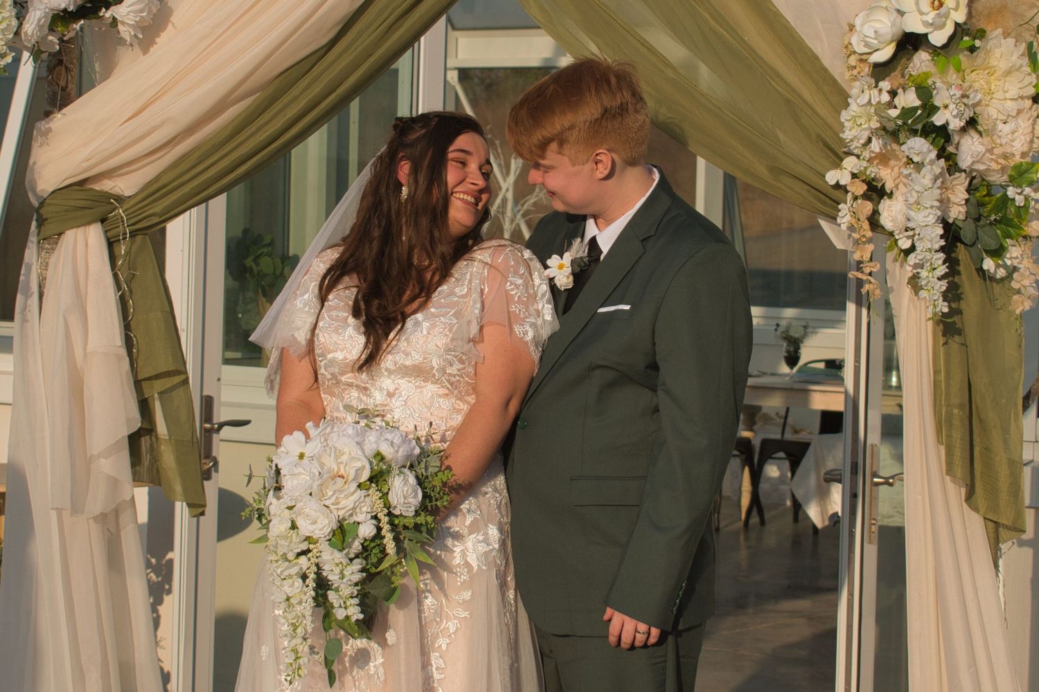 Bride and groom laughing during formal pictures