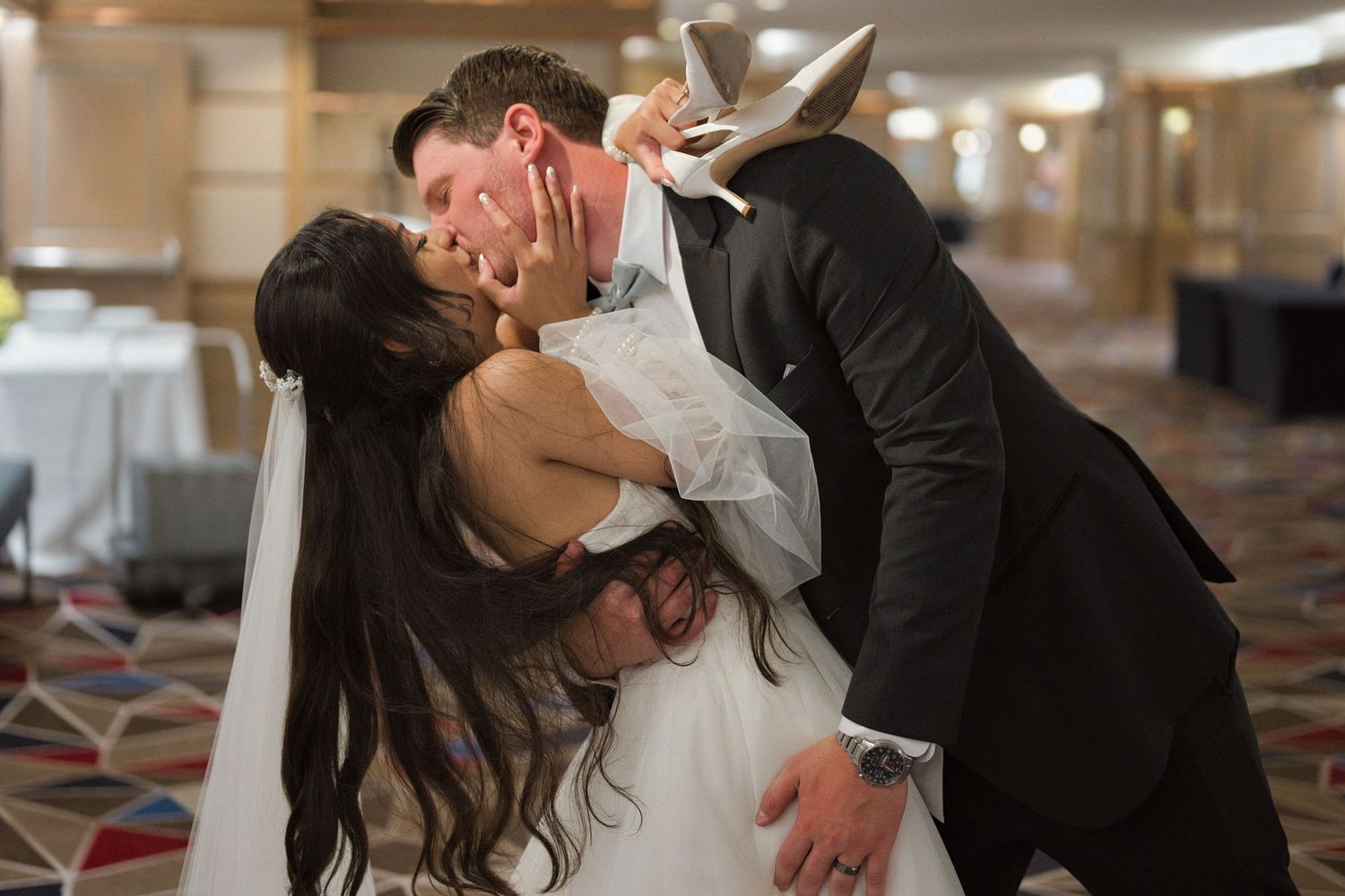 Married couple passionately kissing after reception