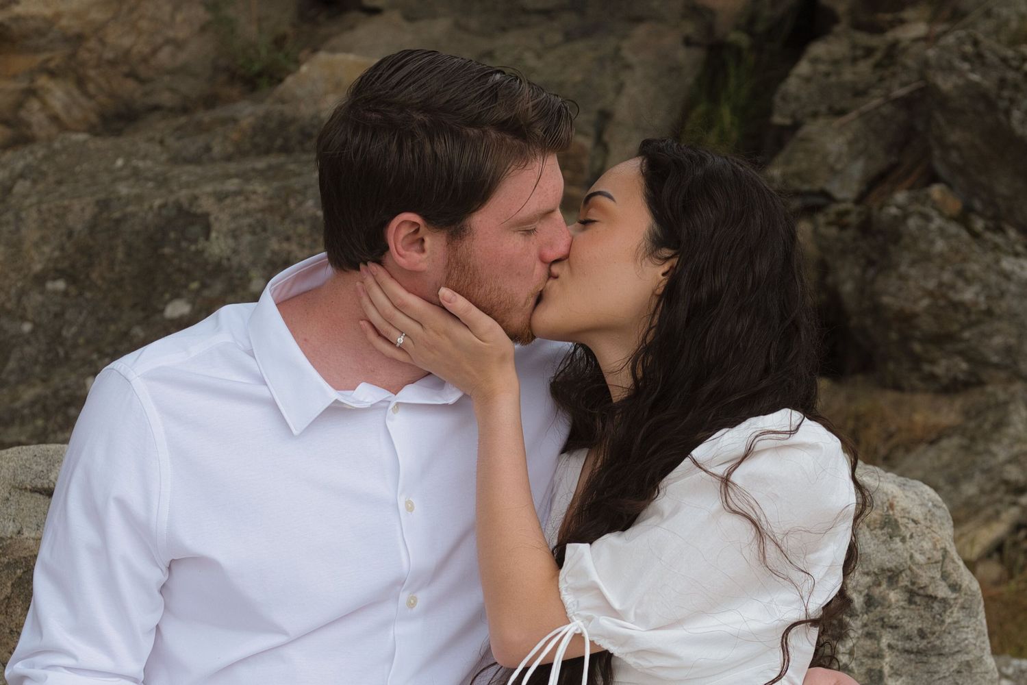 Engaged couple kissing on Tubbs Hill in North Idaho