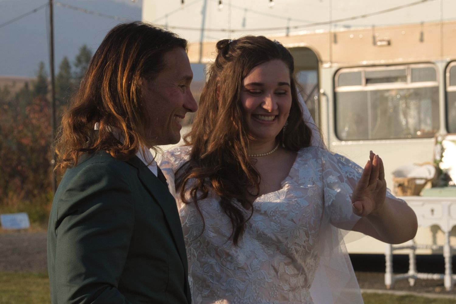 Candid moment as bride shows her ring to her father
