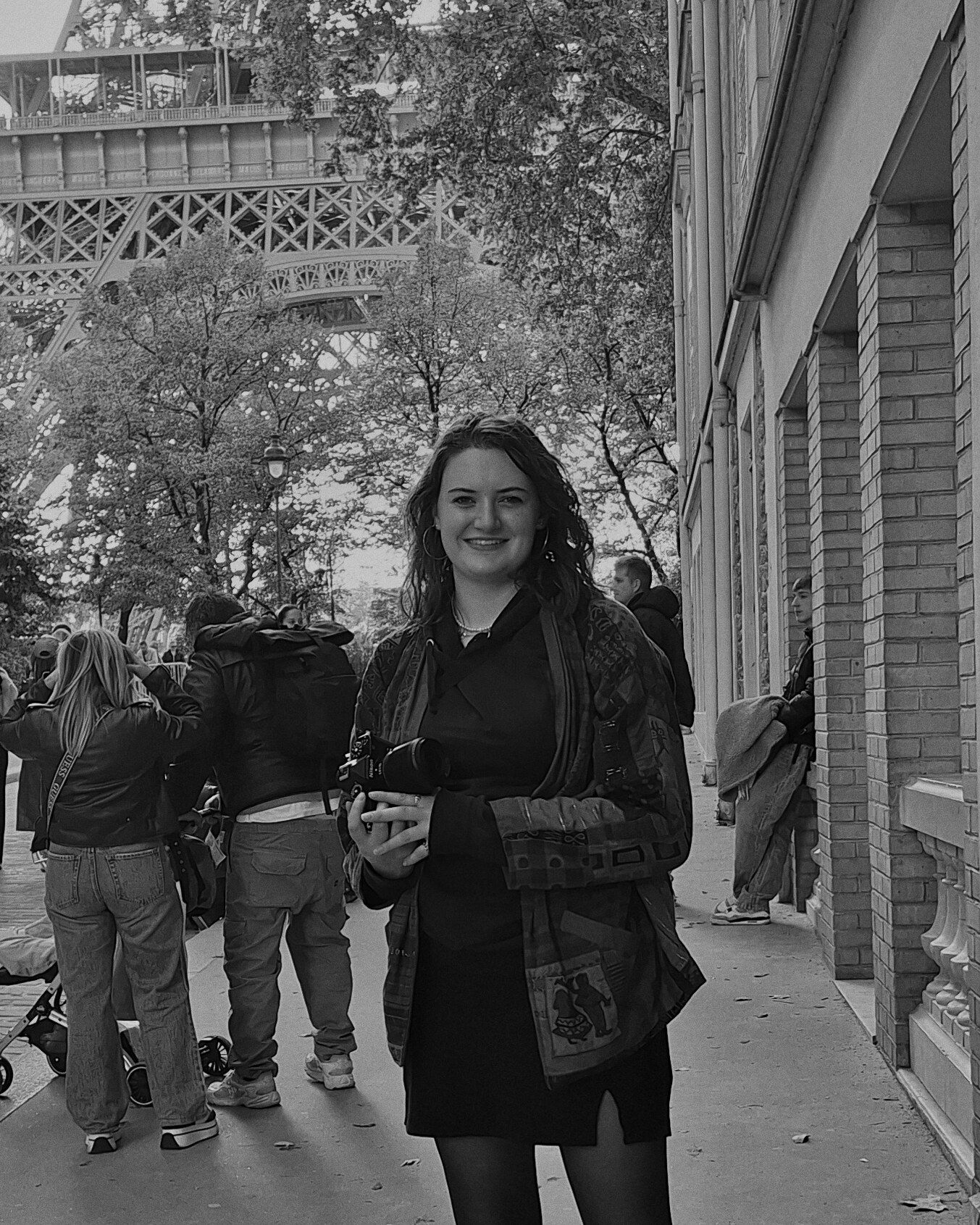 Photographer posing for portrait with camera