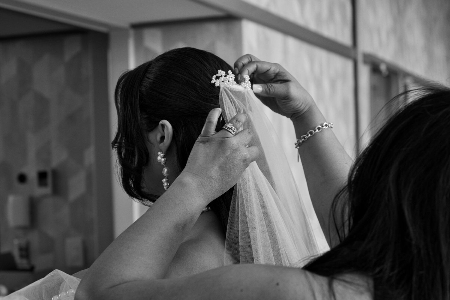Mother of the bride attaching veil to bride's hair in Coeur d' Alene, Idaho