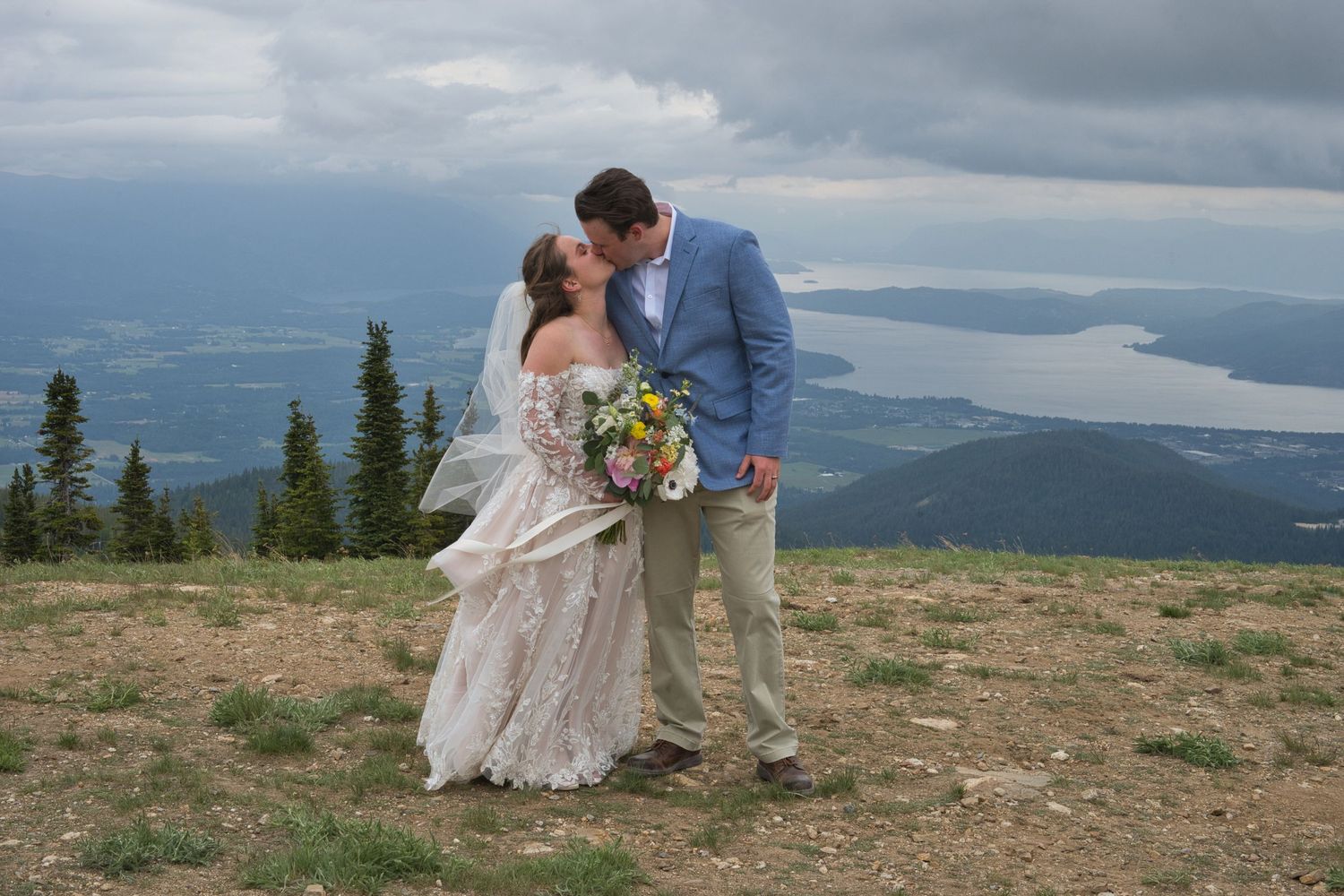 Couple kiss at mountaintop in Sandpoint, Idaho