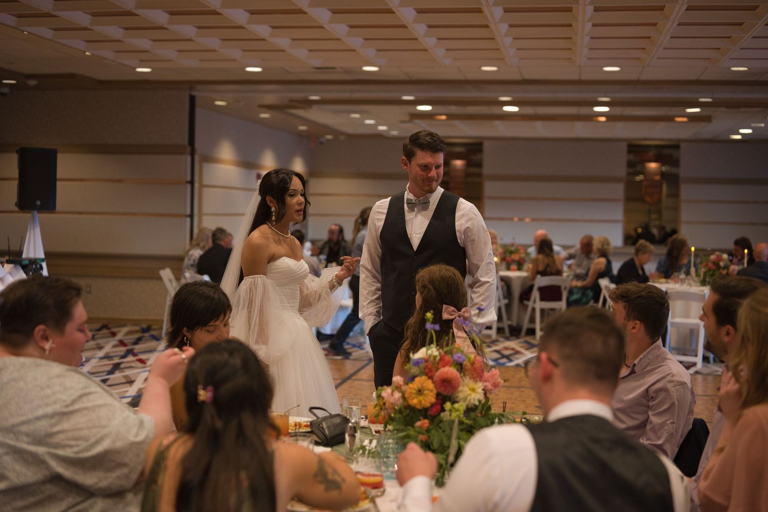 Bride and groom greet guests together at tables around a Coeur d' Alene Resort boardroom.