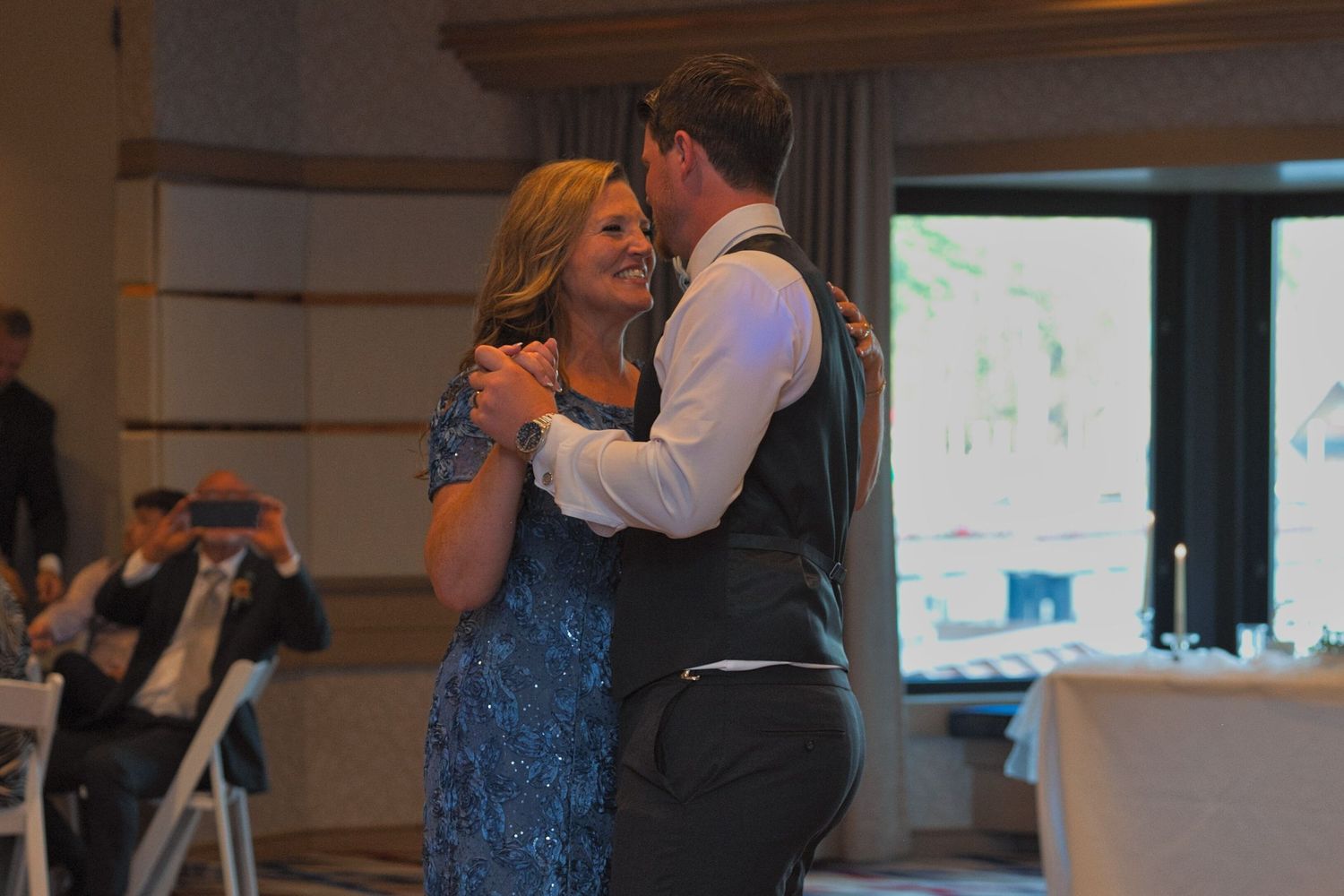 Groom's mother smiles as she dances with the groom during the Mother-Son dance during the reception.