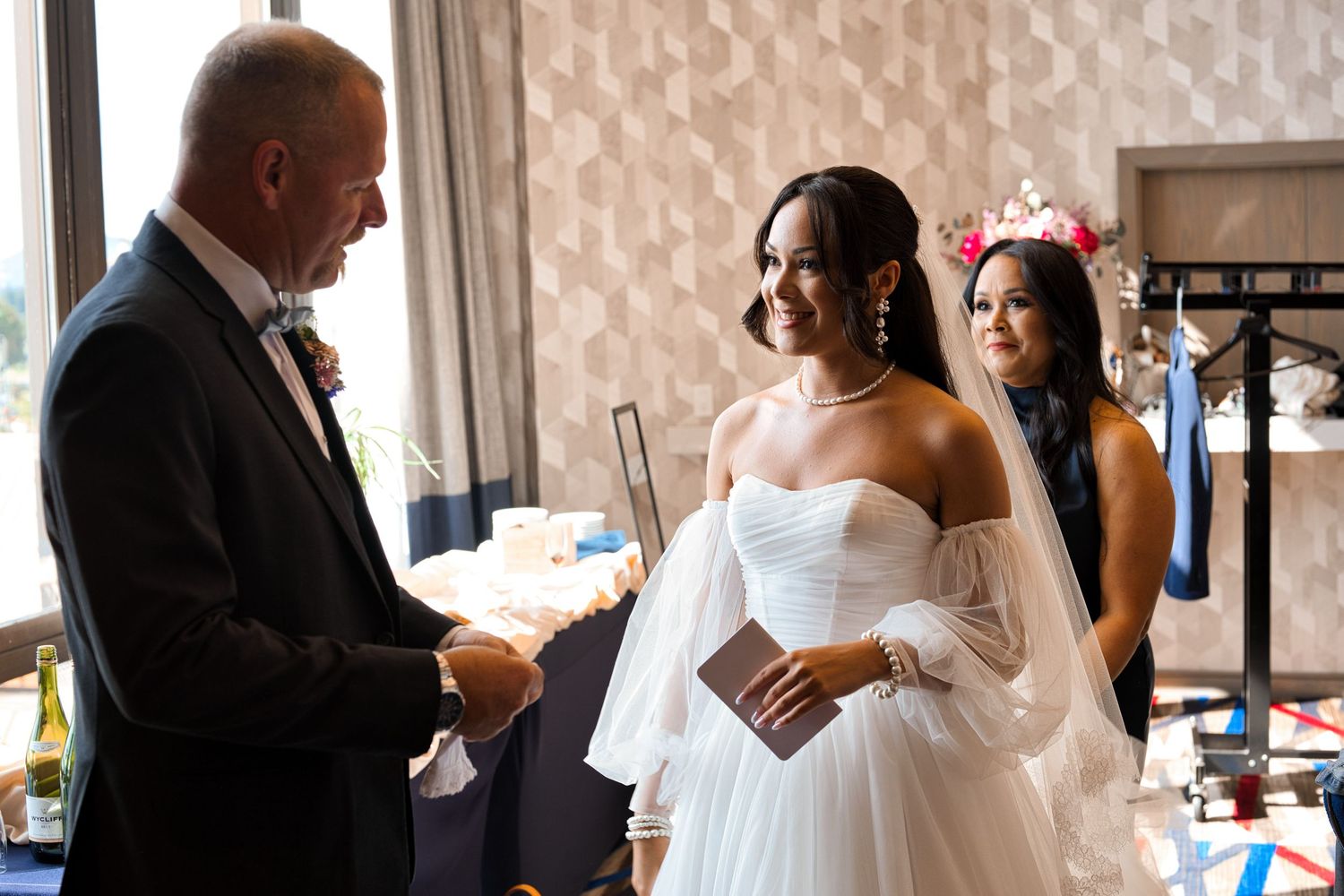 Bride and her father smile at each other