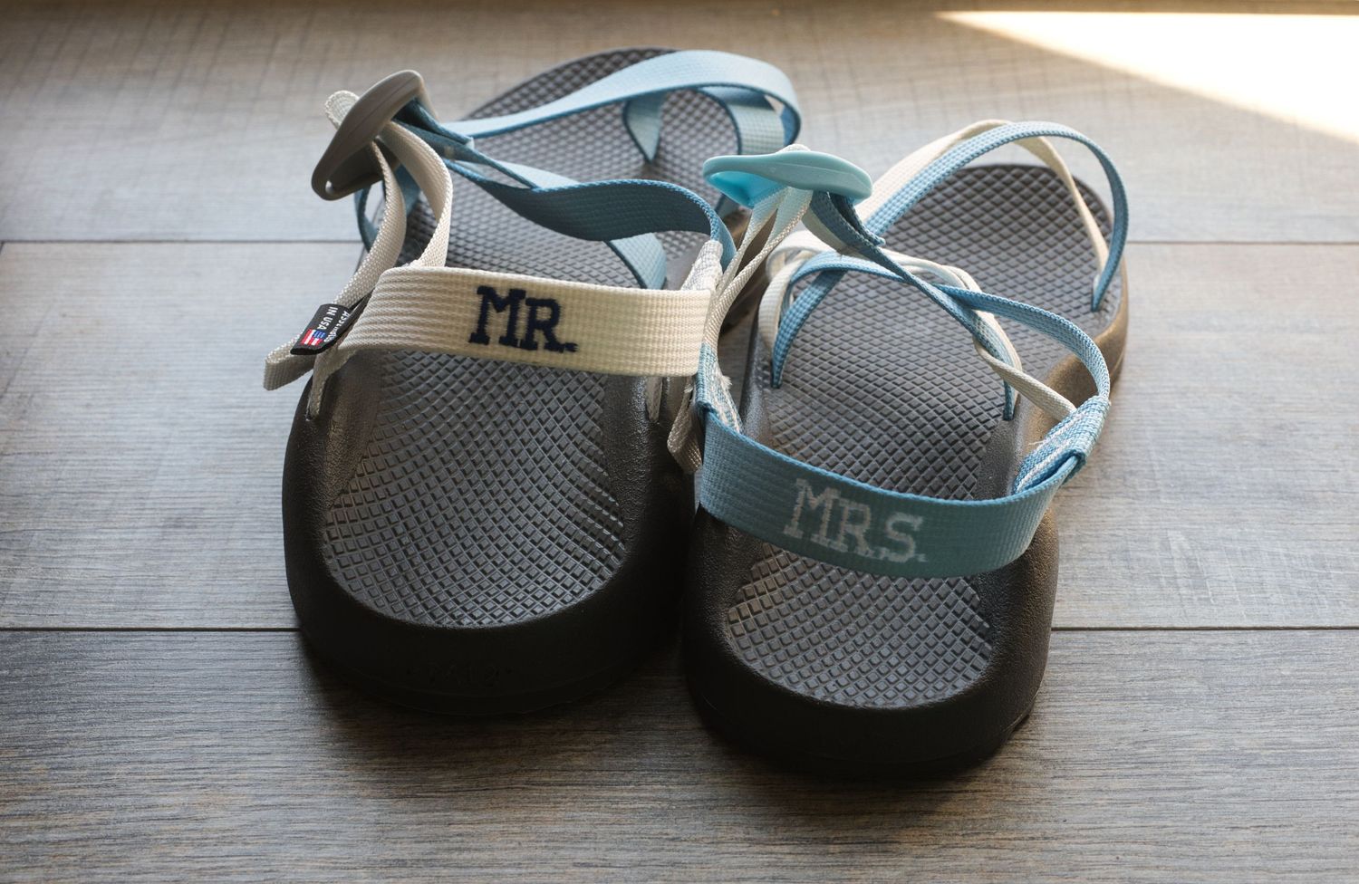 Custom sandals for the bride and groom, with 'Mr.' and 'Mrs.' stitched across the back.