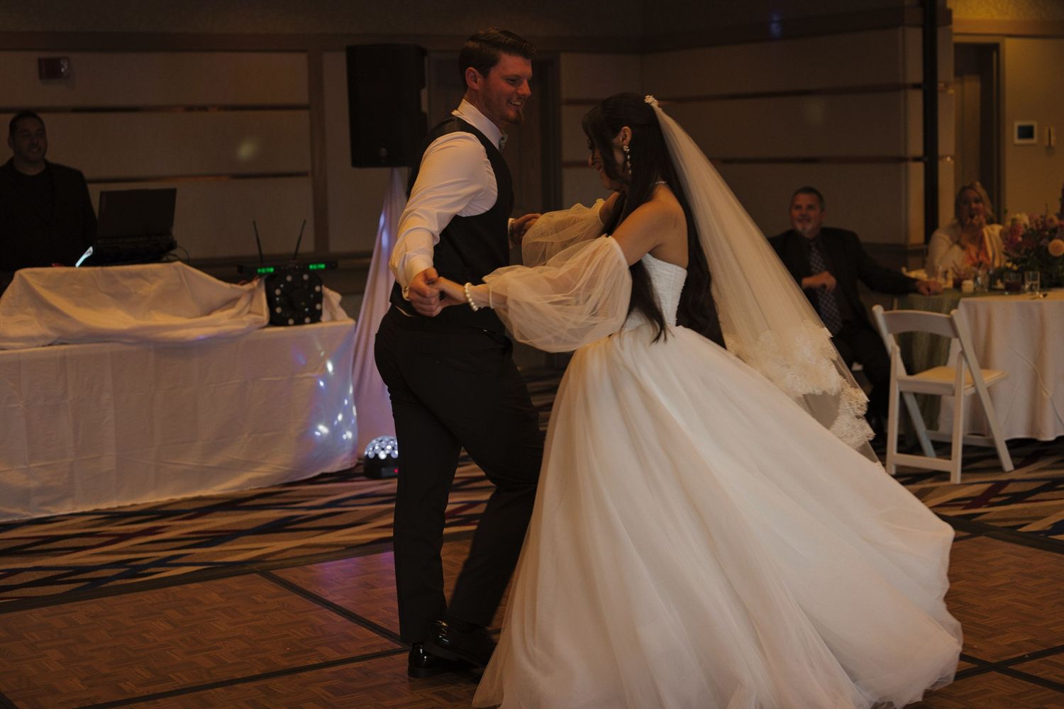 Bride and groom spin together as they dance during the formal first dance as a married couple in the Coeur d' Alene Resort.